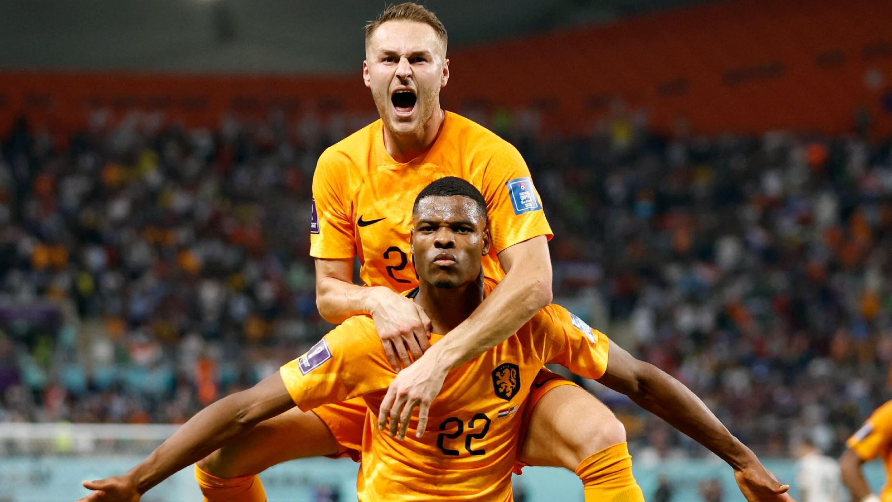 Netherlands' Denzel Dumfries celebrates with Teun Koopmeiners after scoring their third goal during their World Cup Round of 16 clash against the United States at Khalifa International Stadium in Doha on Saturday