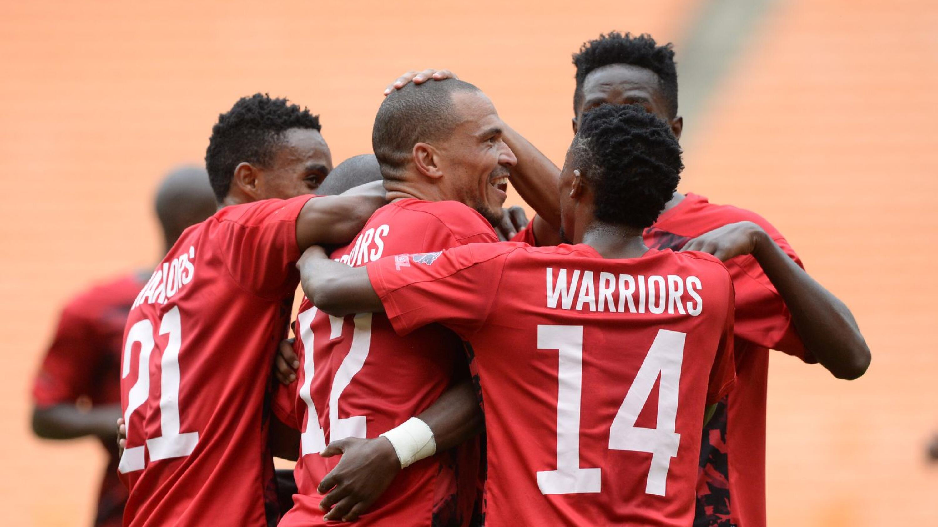 Warriors players celebrate with Ruzaigh Gamildien after he scored a late winner during their 2022 DStv Compact Cup Final against Coastal United at FNB Stadium in Johannesburg on Saturday