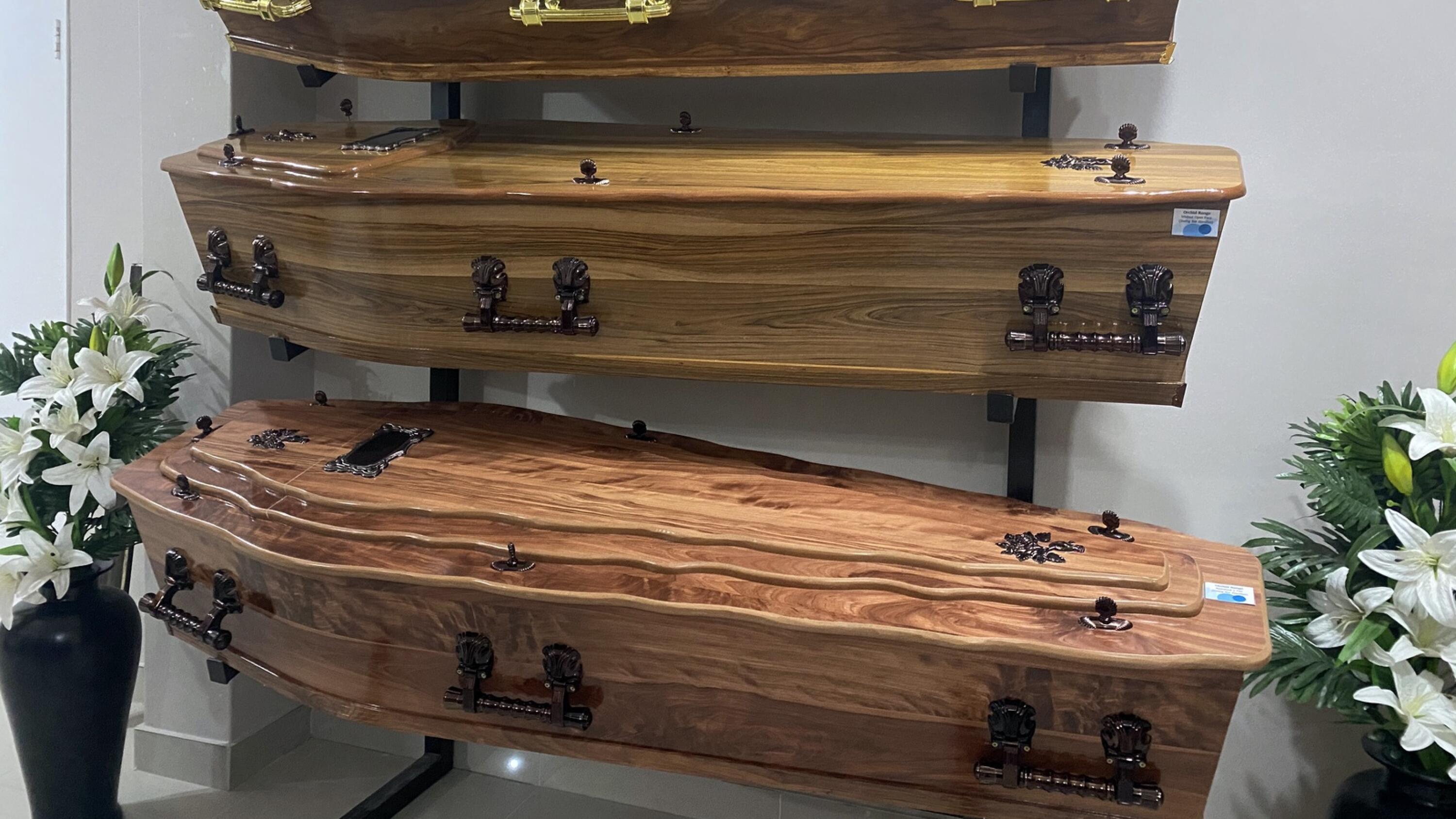 Coffins arranged on a stand 