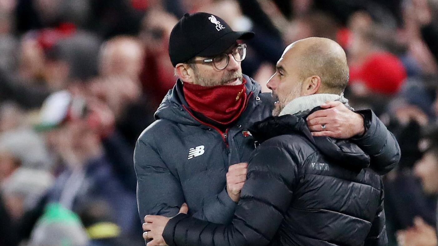 Liverpool manager Jurgen Klopp and Manchester City boss Pep Guardiola embrace