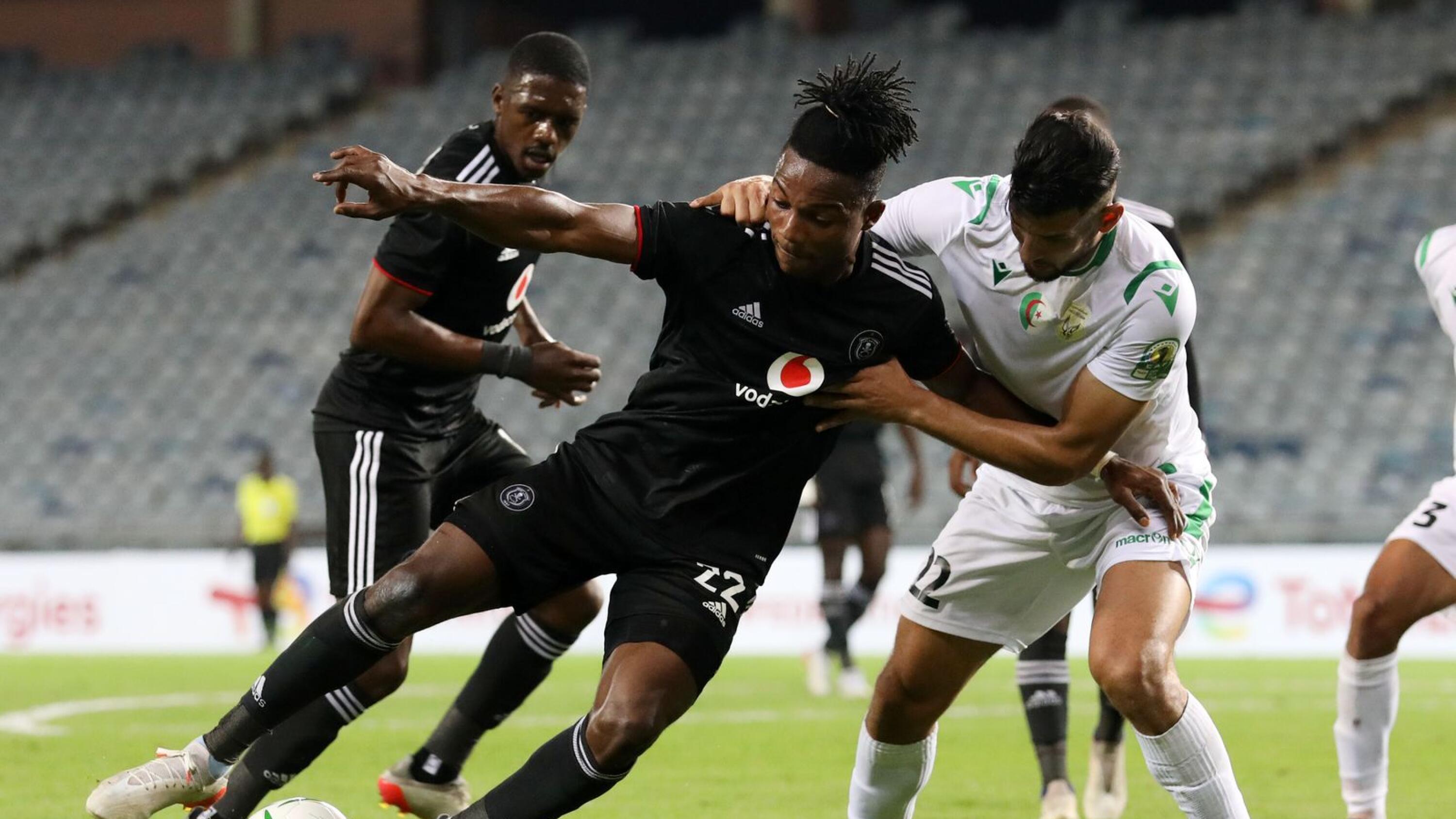 Kwame Peprah of Orlando Pirates shields the ball from Imadeddine Boubekeur of JS Saoura during their CAF Confederation Cup match at Orlando Stadium in Soweto on Sunday
