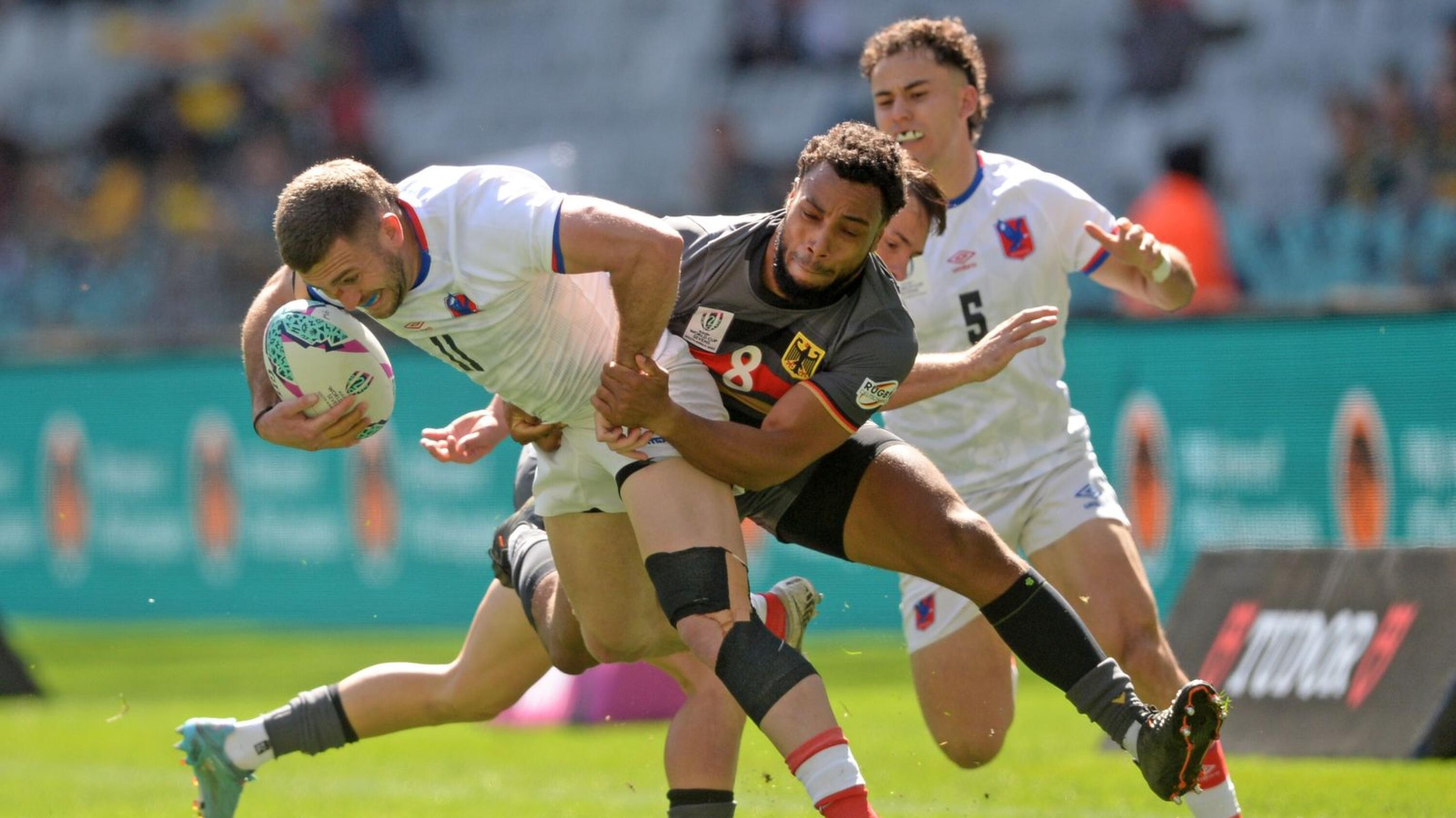 Julio Blanc of Chile is tackled by Ben Ellermann of Germany during day one of the South Africa Rugby World Cup Sevens tournament at Cape Town Stadium.