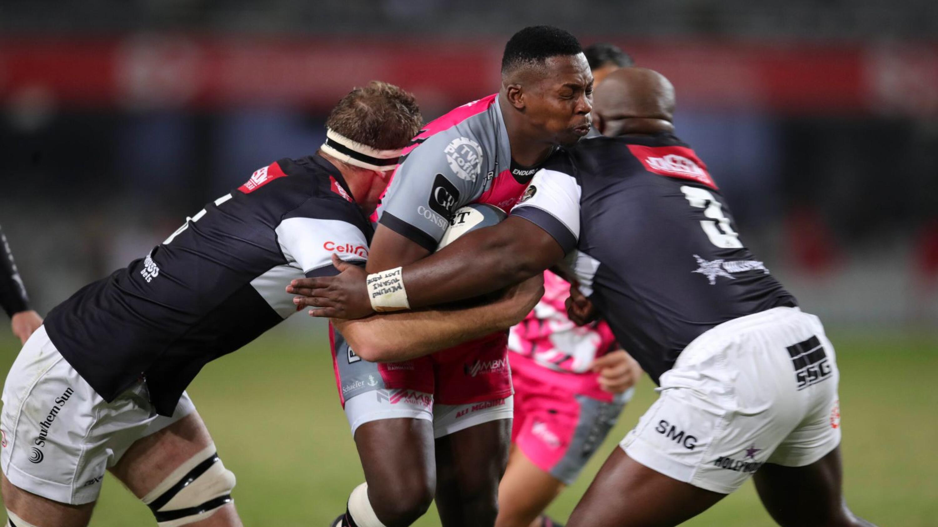Ali Mgijima of Pumas is challenged by Reniel Hugo and Khuthazani Mchunu of the Sharks during their Currie Cup semi-final at Kings Park in Durban on Saturday