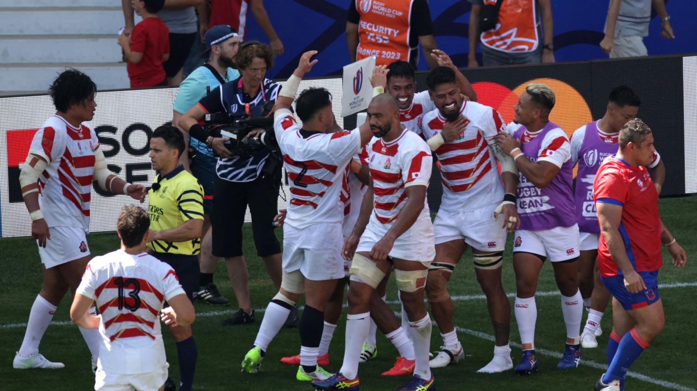 Japan players celebrate with lock Amato Fakatava after he scored their third try during their Rugby World Cup Pool D match against Chile
