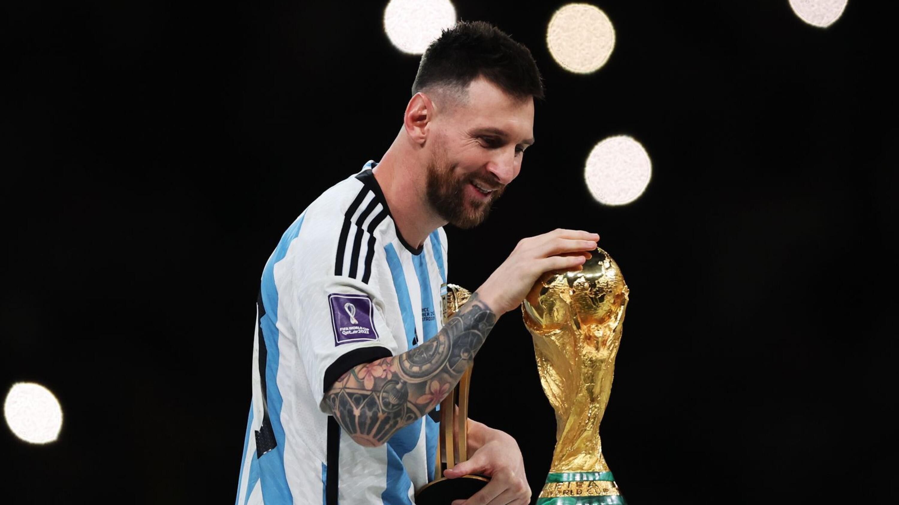 Lionel Messi of Argentina touches the World Cup trophy