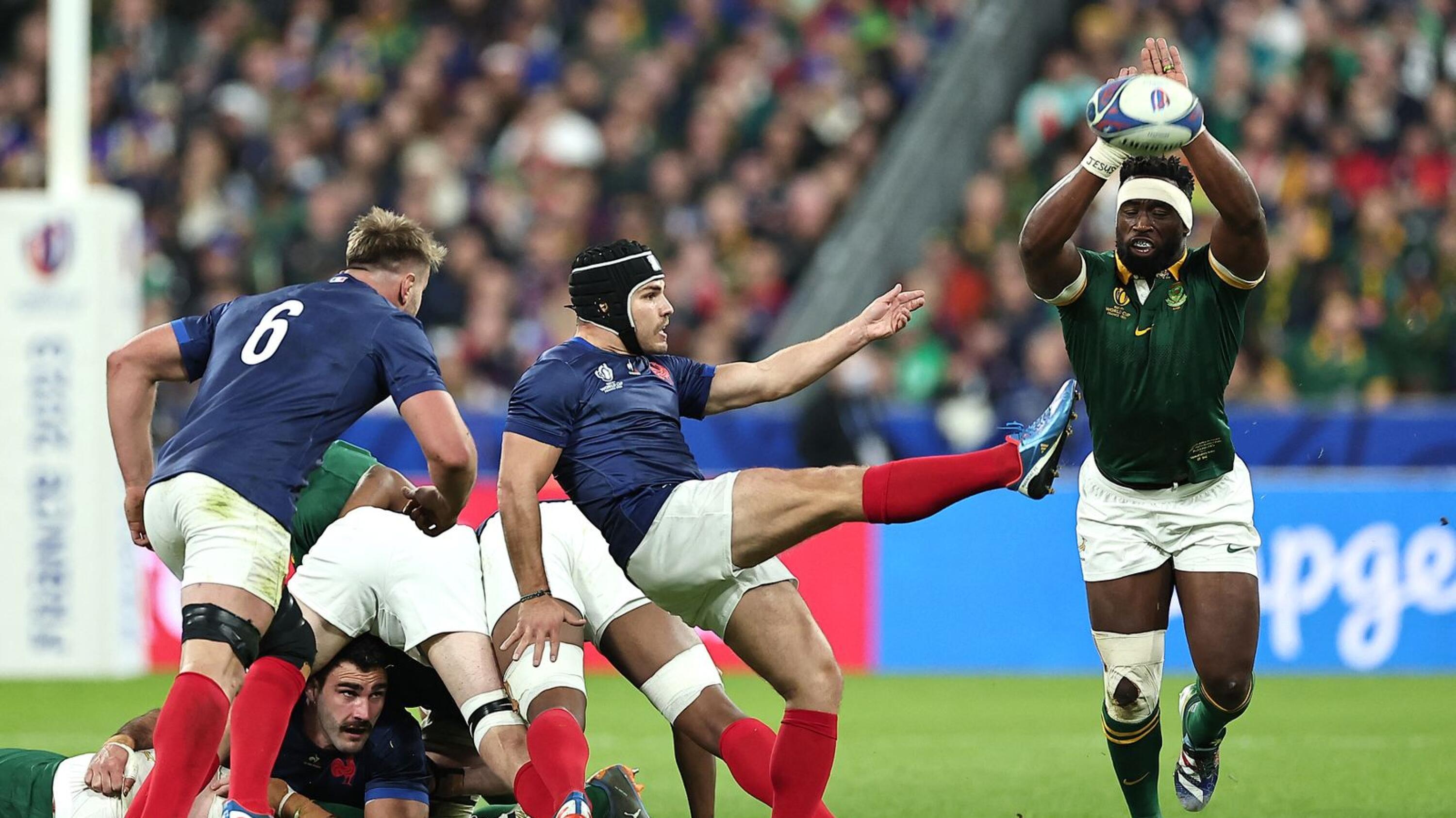 South Africa's Siya Kolisi attempts to charge down a kick from France's Antoine Dupont during their Rugby World Cup quarter-final at the Stade de France
