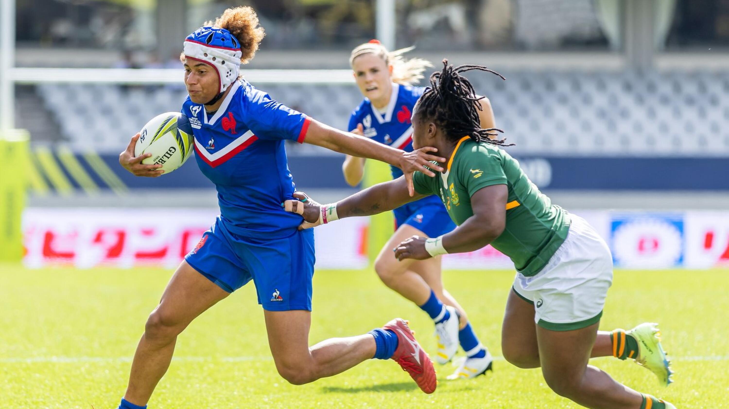 two women’s rugby players in action