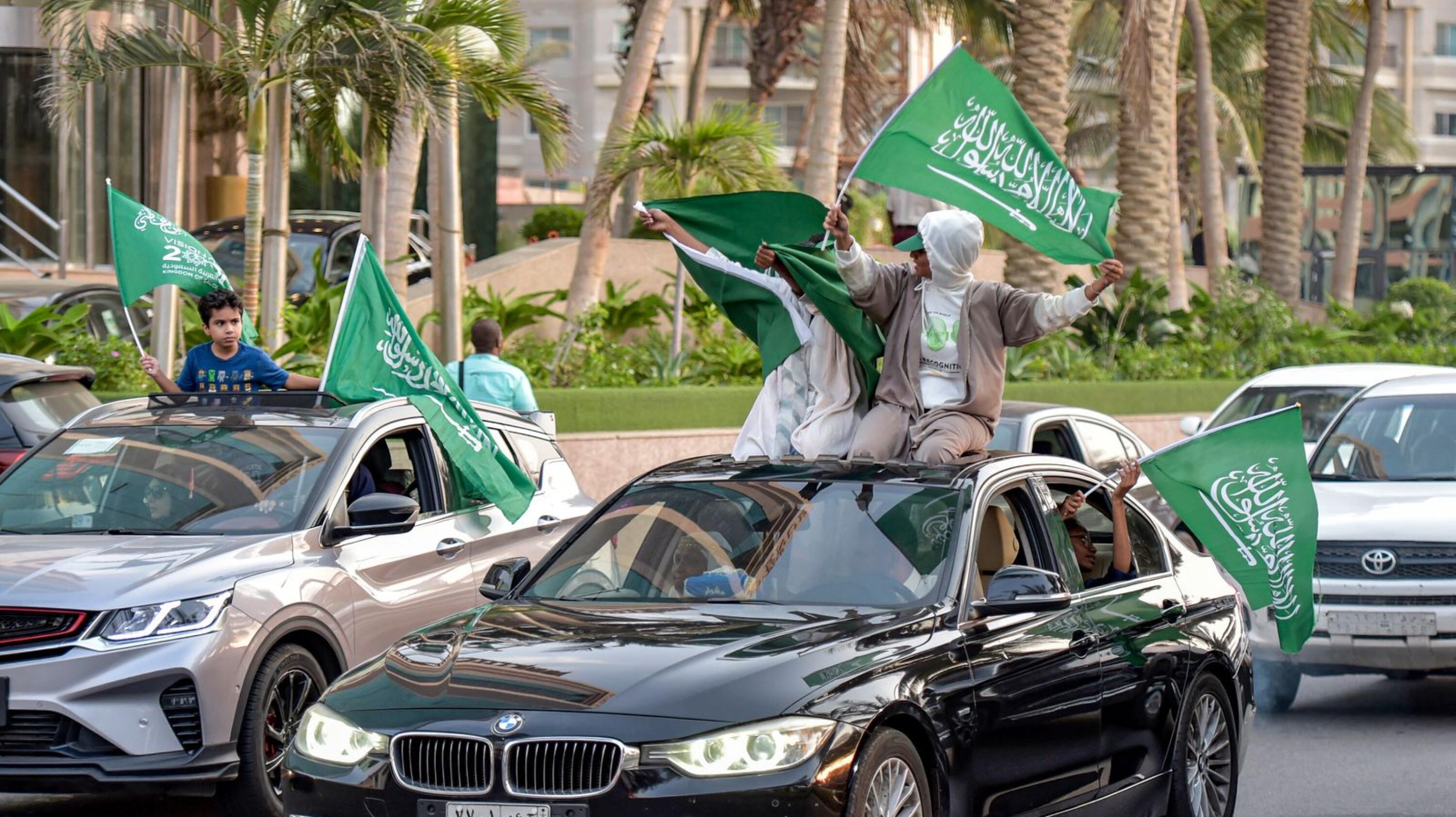 Saudi football fans wave their country's flags from vehicles as they celebrate their win over Argentina at the Qatar 2022 World Cup, in the capital Riyadh on Tuesday