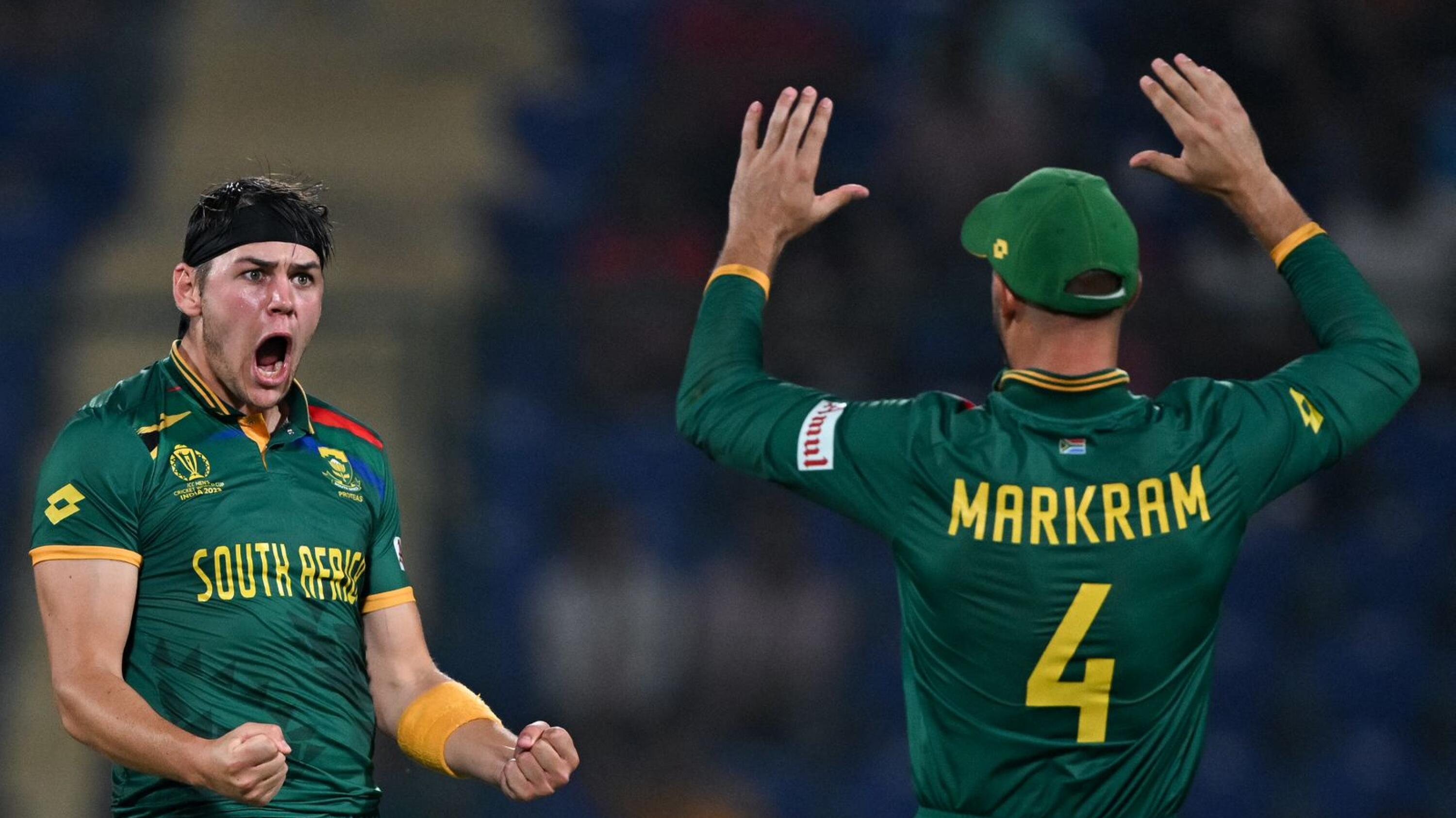 South Africa's Gerald Coetzee celebrates with teammate Aiden Markram after taking the wicket of Sri Lanka's Dunith Wellalage during their Cricket World Cup match