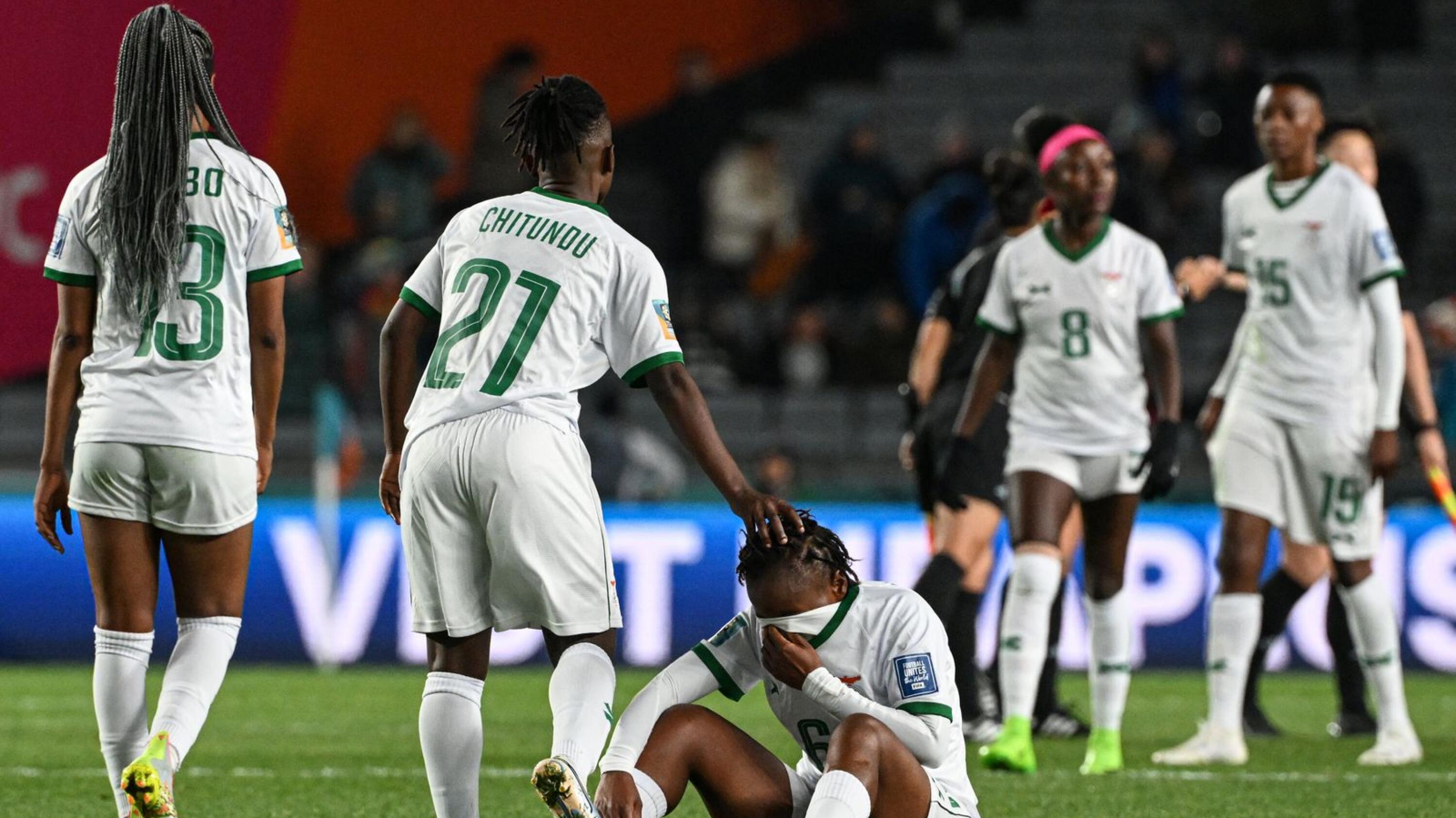 Zambia's midfielder Mary Wilombe (centre) is comforted after losing against Spain in their  Women's World Cup Group C football match at Eden Park in Auckland