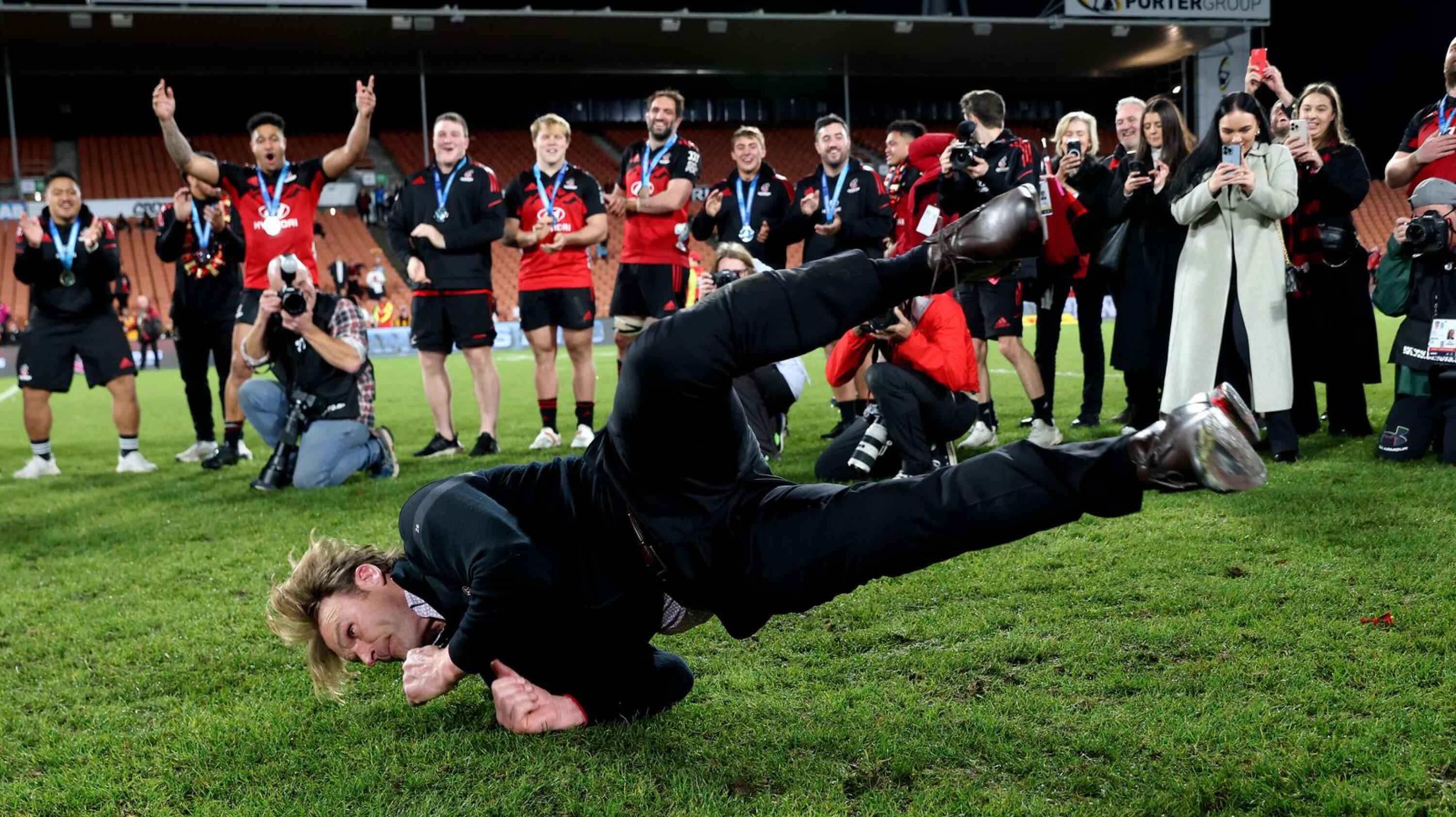 Crusaders head coach Scott Robertson celebrates with some break dance moves after winning the Super Rugby Pacific final against the Chiefs at FMG Stadium in Hamilton on Saturday