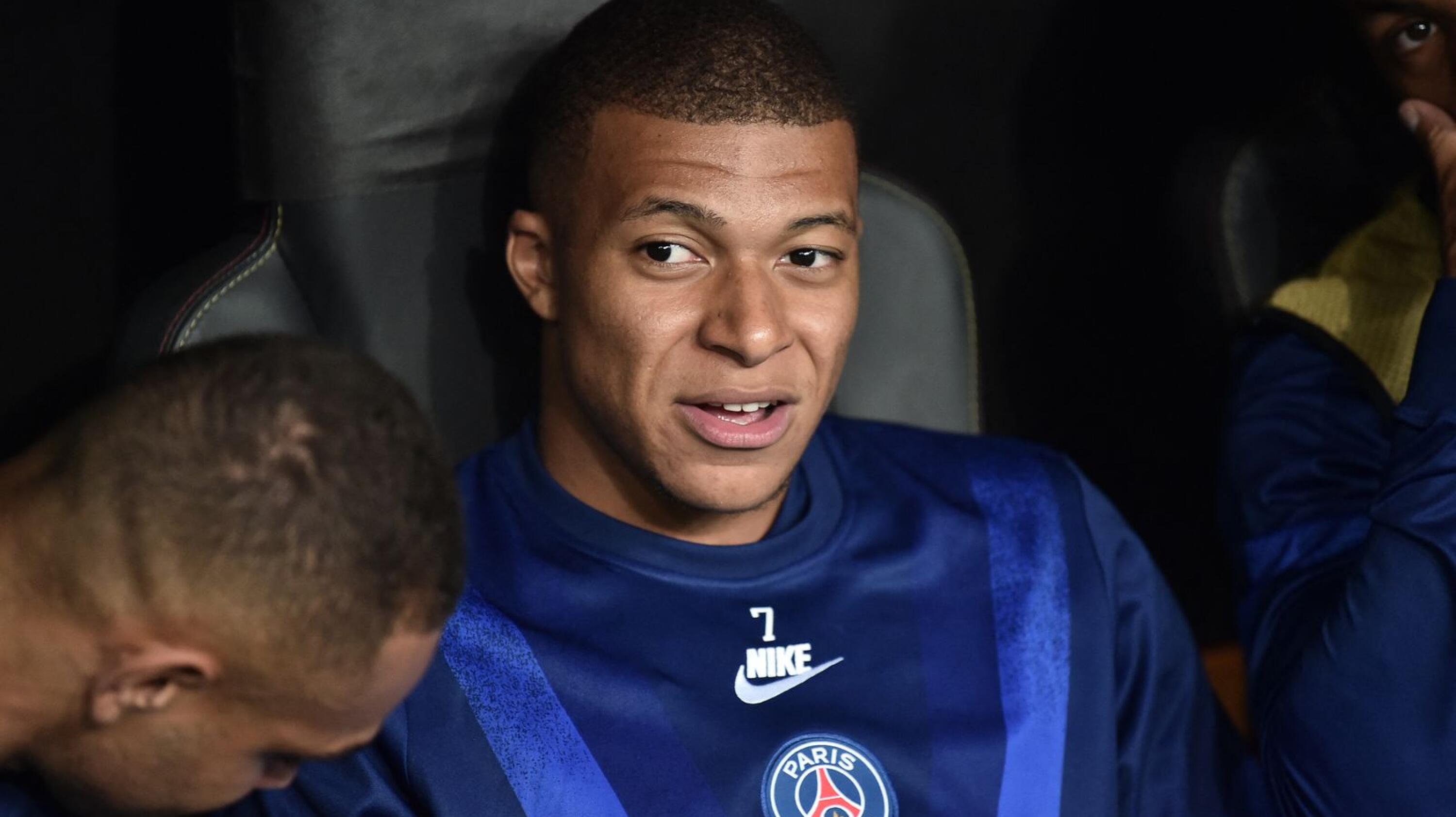 Paris Saint-Germain's Kylian Mbappe is seen on the substitutes' bench during a UEFA Champions League game