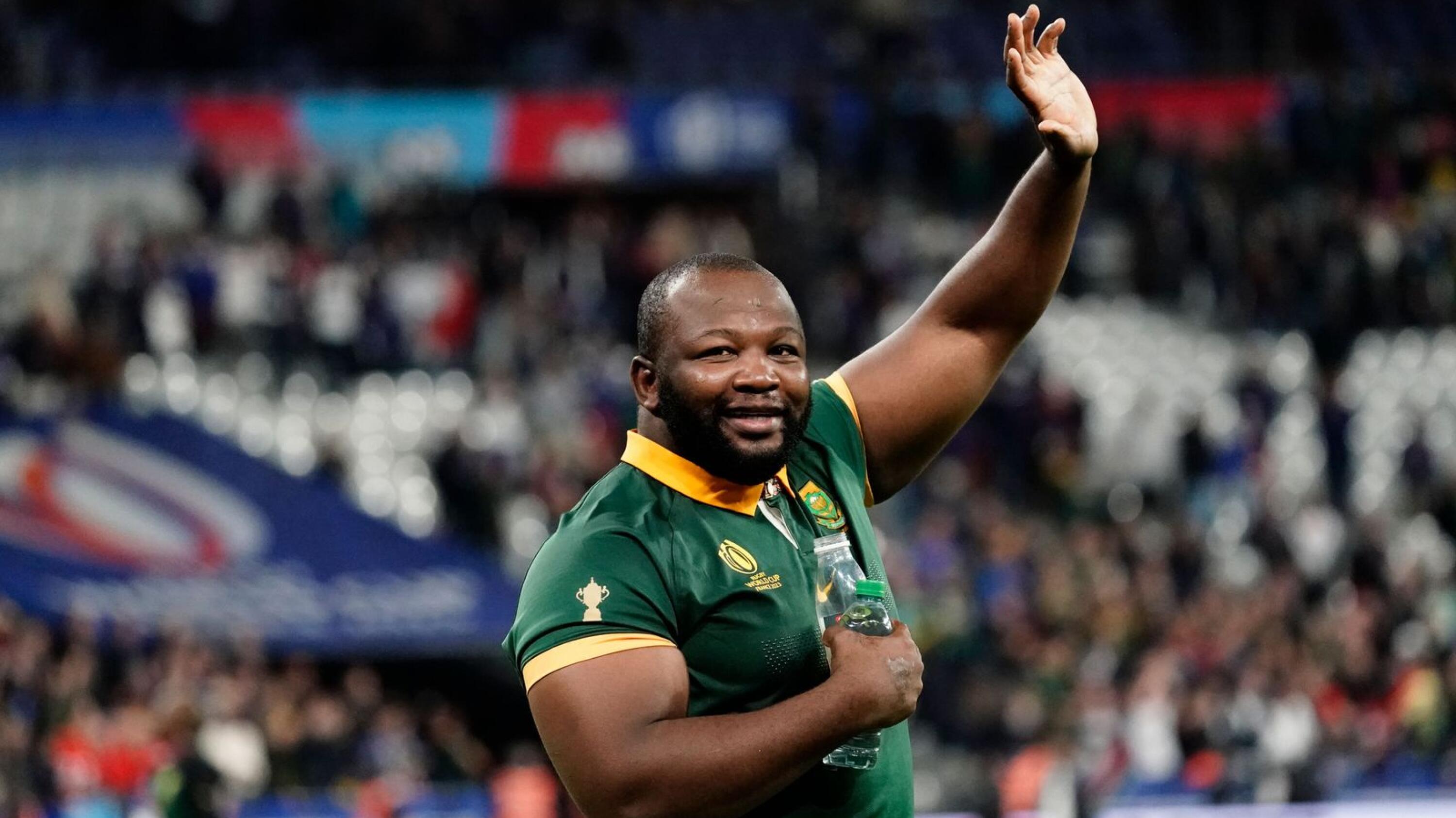 Springboks prop Ox Nche does a lap of honour with his teammates during the Rugby World Cup.