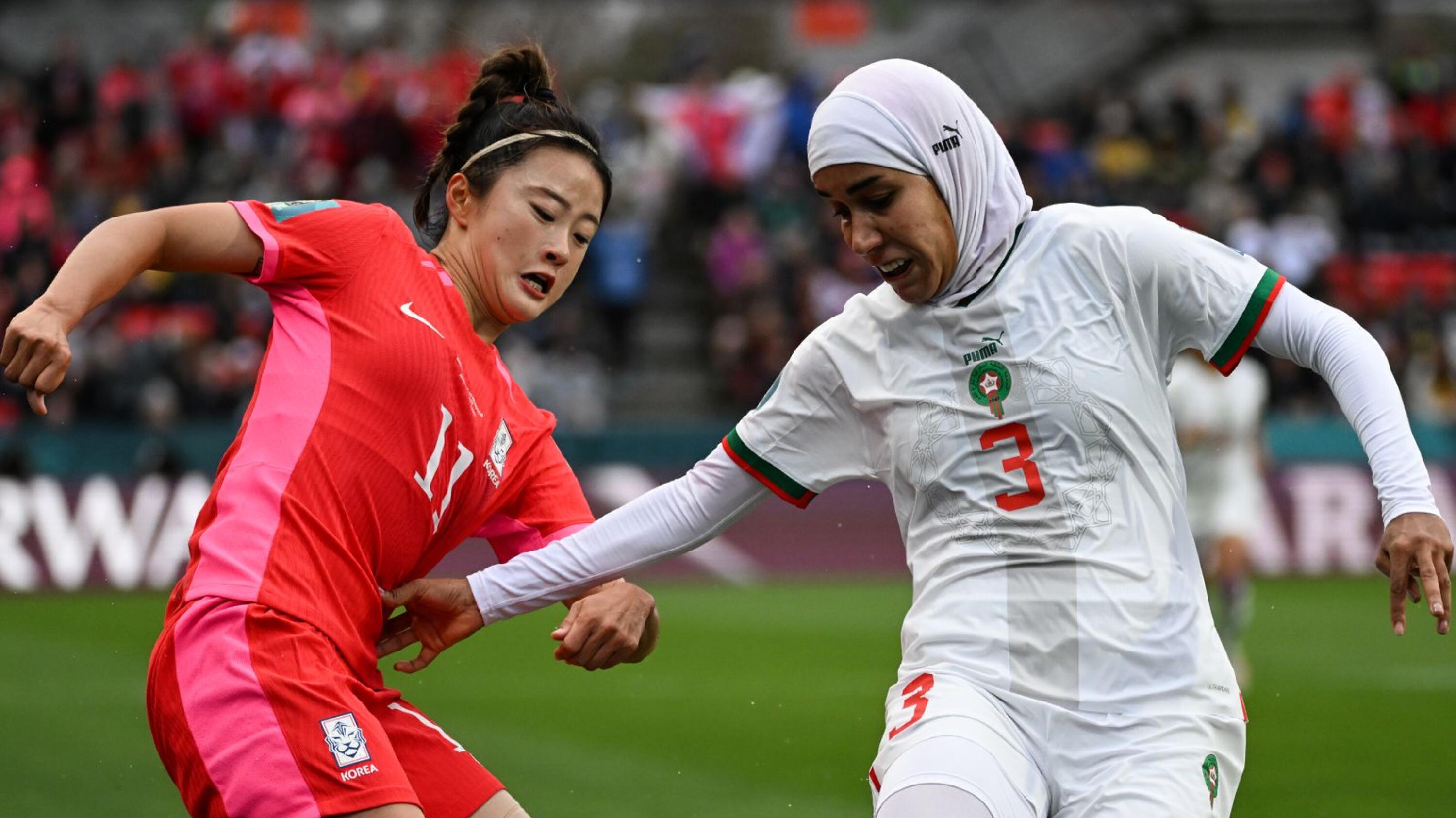 South Korea's forward #11 Choe Yu-Ri (L) and Morocco's defender #03 Nouhaila Benzina fight for the ball