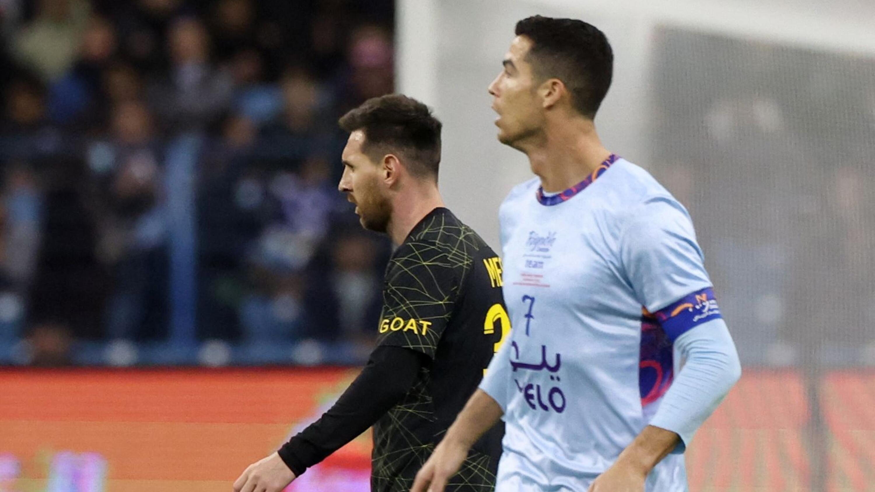 Paris Saint-Germain's Lionel Messi and Riyadh All-Star's Cristiano Ronaldo are pictured on the pitch during the Riyadh Season Cup football match at the King Fahd Stadium in Riyadh on Thurday