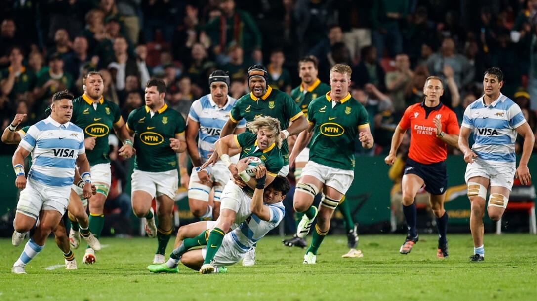 South Africa's scrumhalf Faf de Klerk runs with the ball as he is tackled during their Rugby Championship match against Argentina at Ellis Park in Johannesburg on Saturday