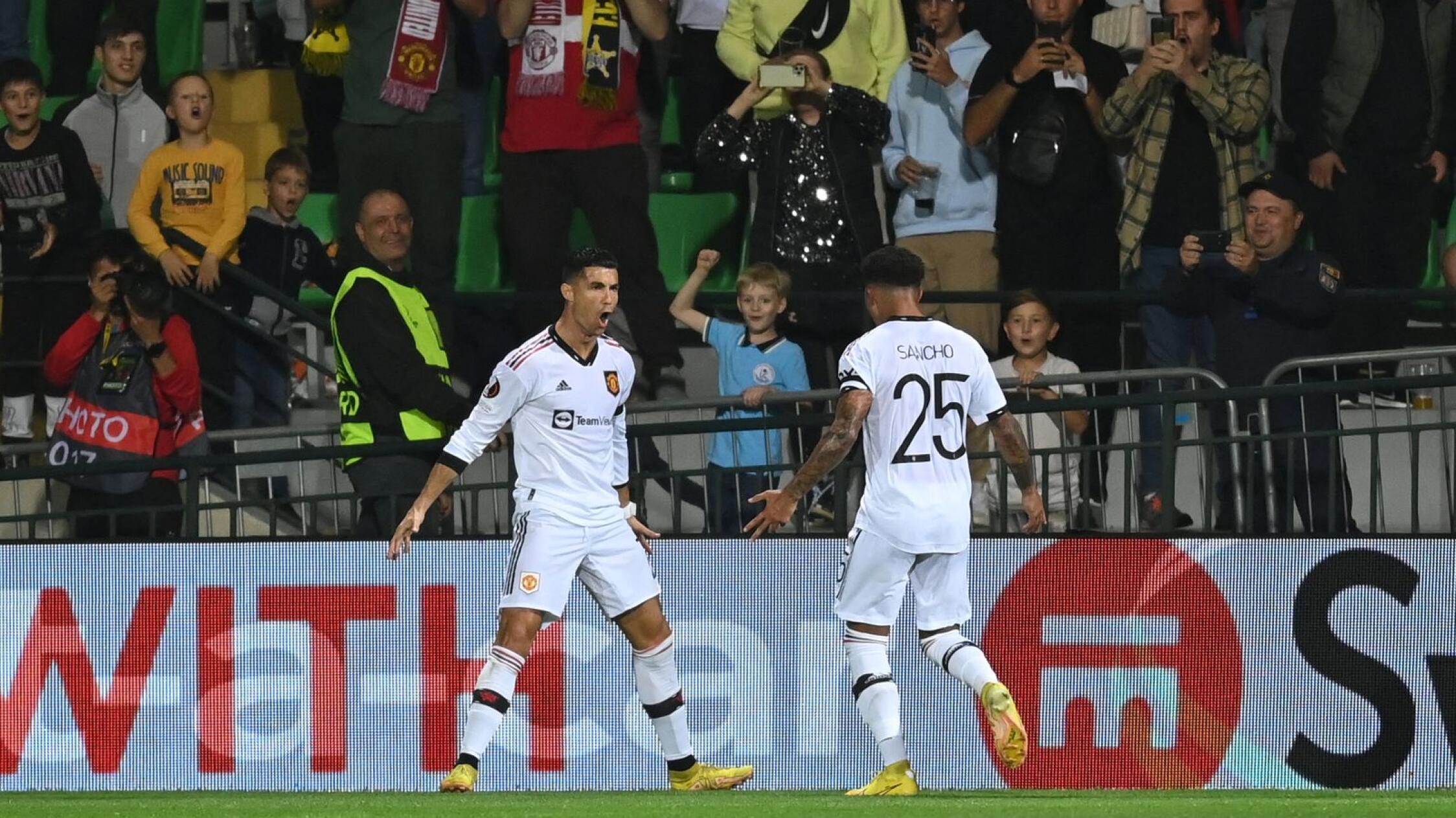 Manchester United's Portuguese striker Cristiano Ronaldo celebrates with Jadon Sancho after scoring the second goal goal during their UEFA Europa League group E football match against Sheriff at Zimbru stadium in Chisinau on Thursday