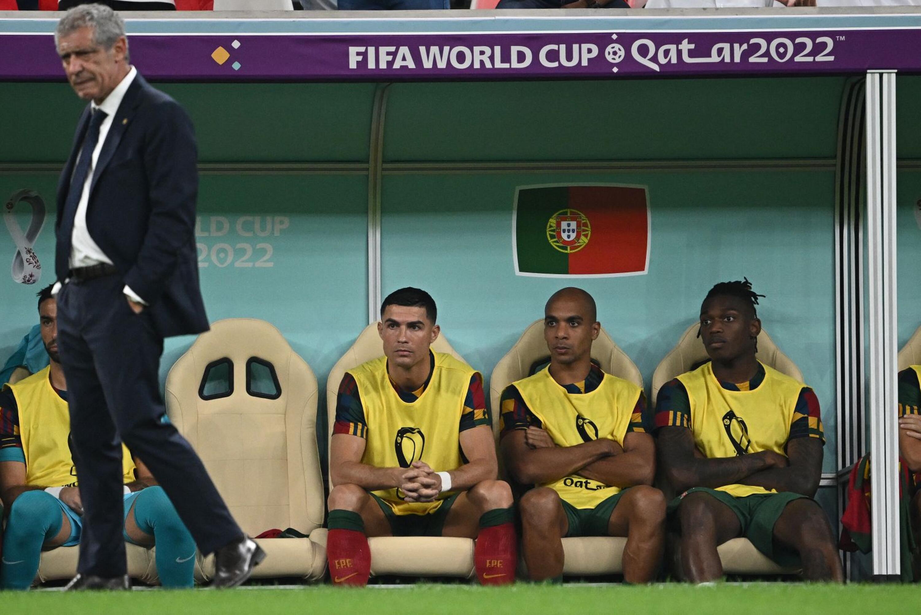 Portugal's Cristiano Ronaldo sits on the bench next to Joao Mario and Rafael Leao during their Qatar 2022 World Cup round of 16 football match against Switzerland