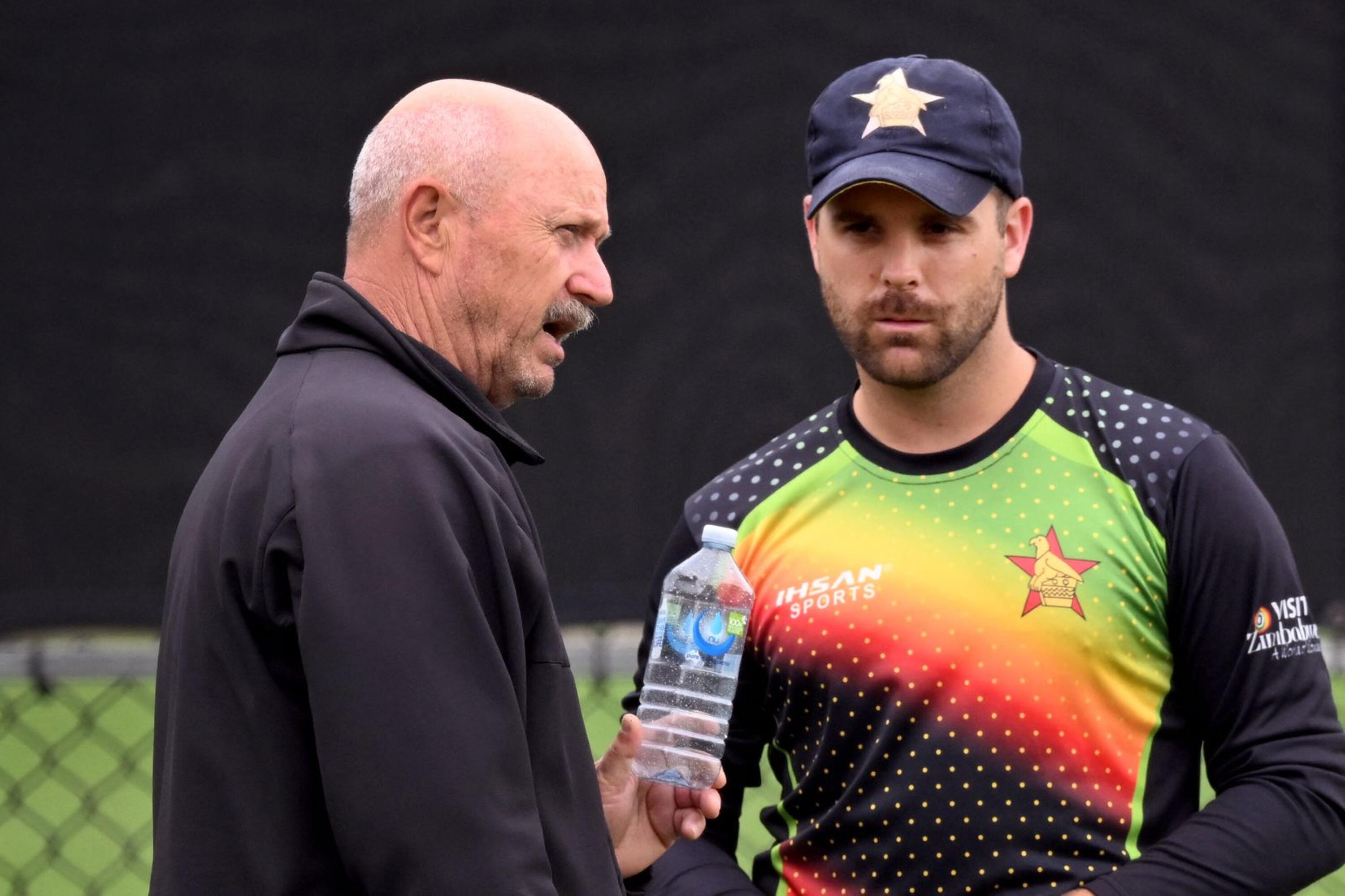Zimbabwe coach Dave Houghton chats to batter Ryan Burl during a training session