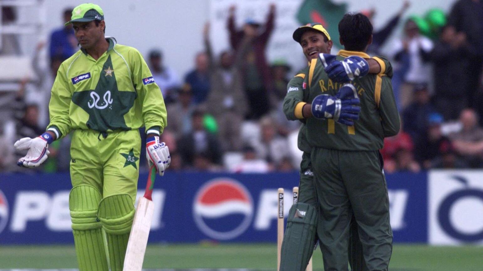 Waqar Younis of Pakistan is bowled out by Mohammed Rafique of Bangladesh, seen celebrating with his wicketkeeper Khaled Masud