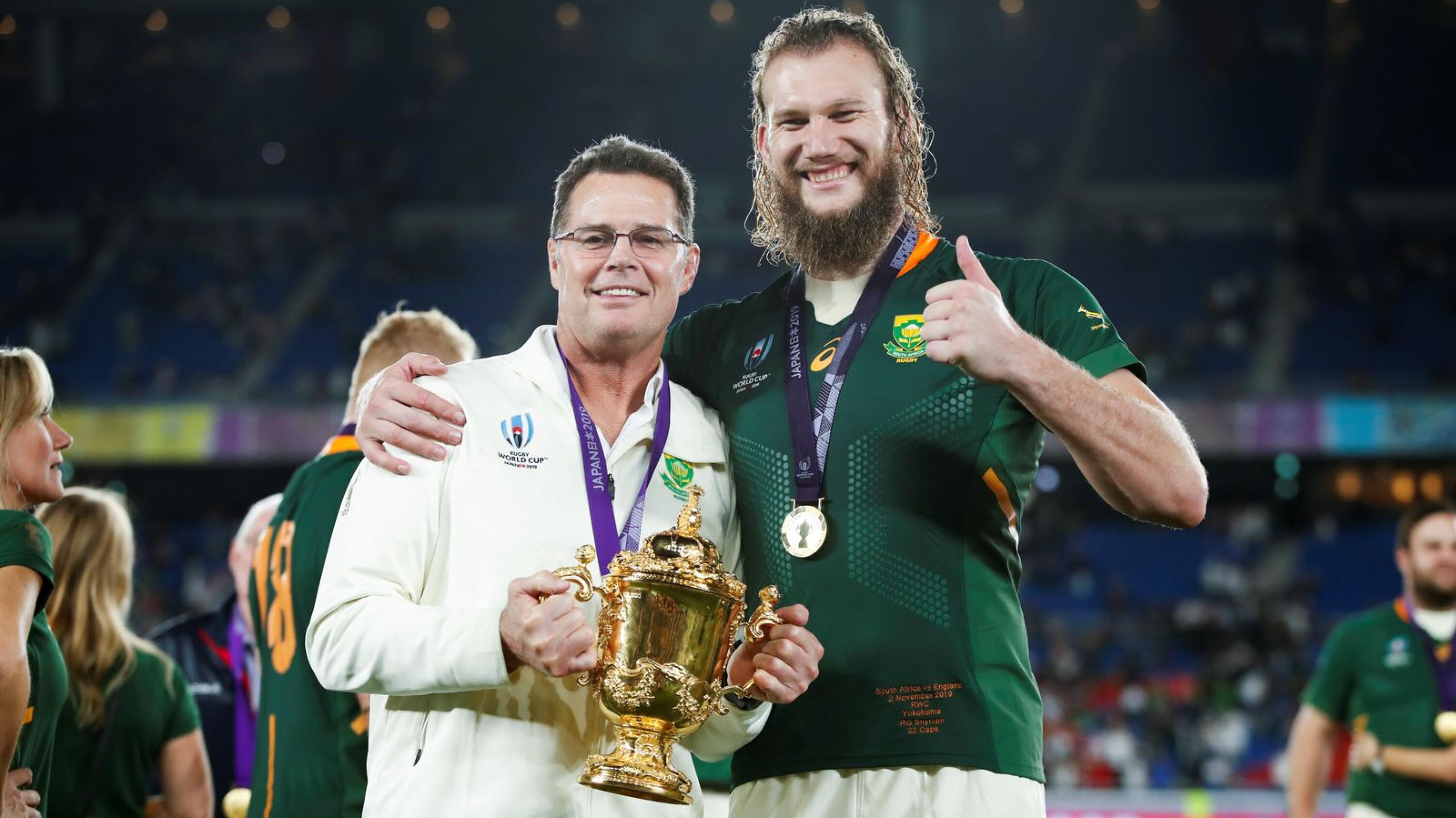 Rassie Erasmus poses with lock RG Snyman following their World Cup final win against England in 2019.