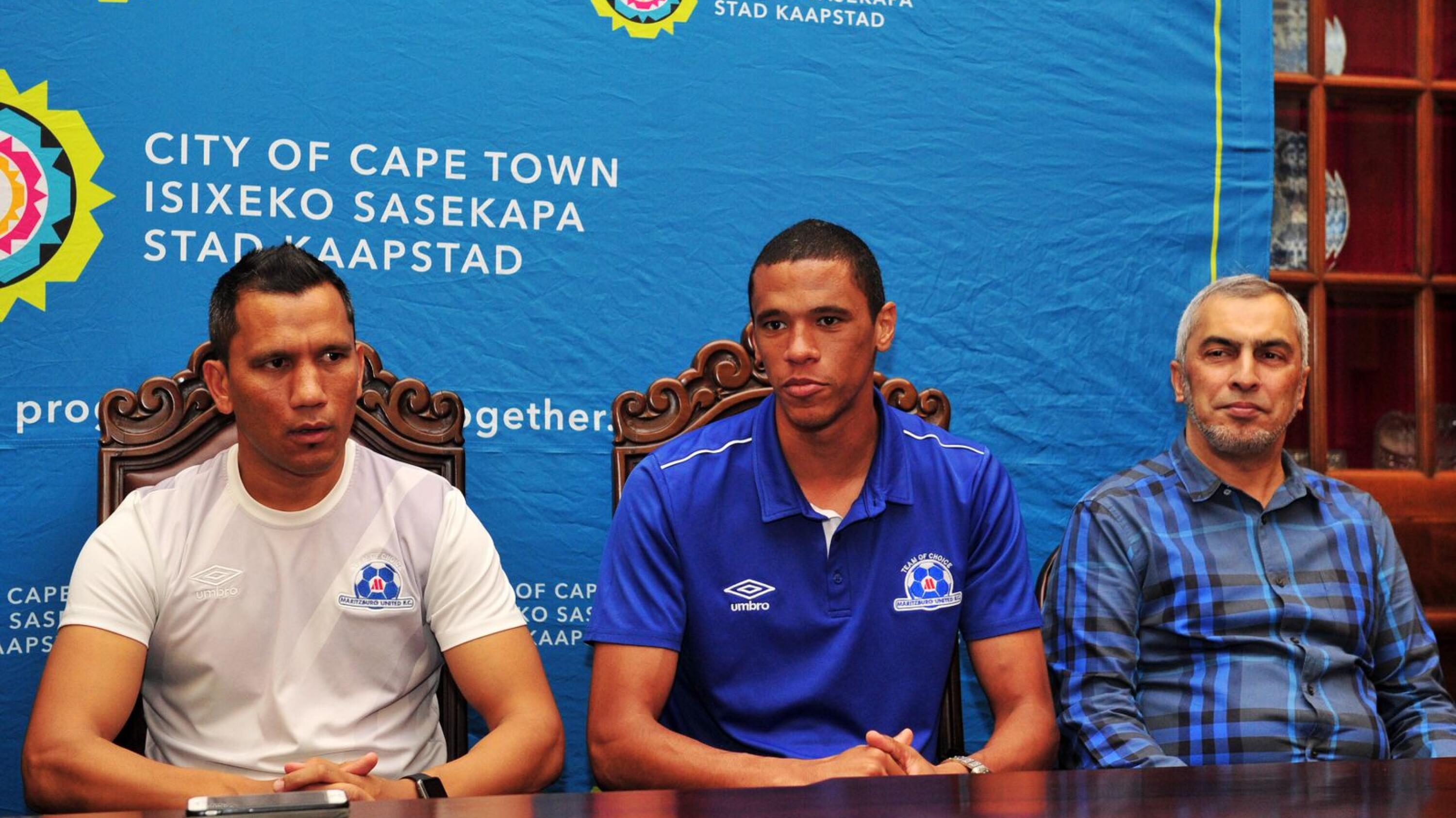 Bevan Fransman of Maritzburg United, flanked by Fadlu Davids (left) and Maritzburg United Chairman Farook Kadodia (right) chats to media at City Hall during the Maritzburg United visit to Cape Town