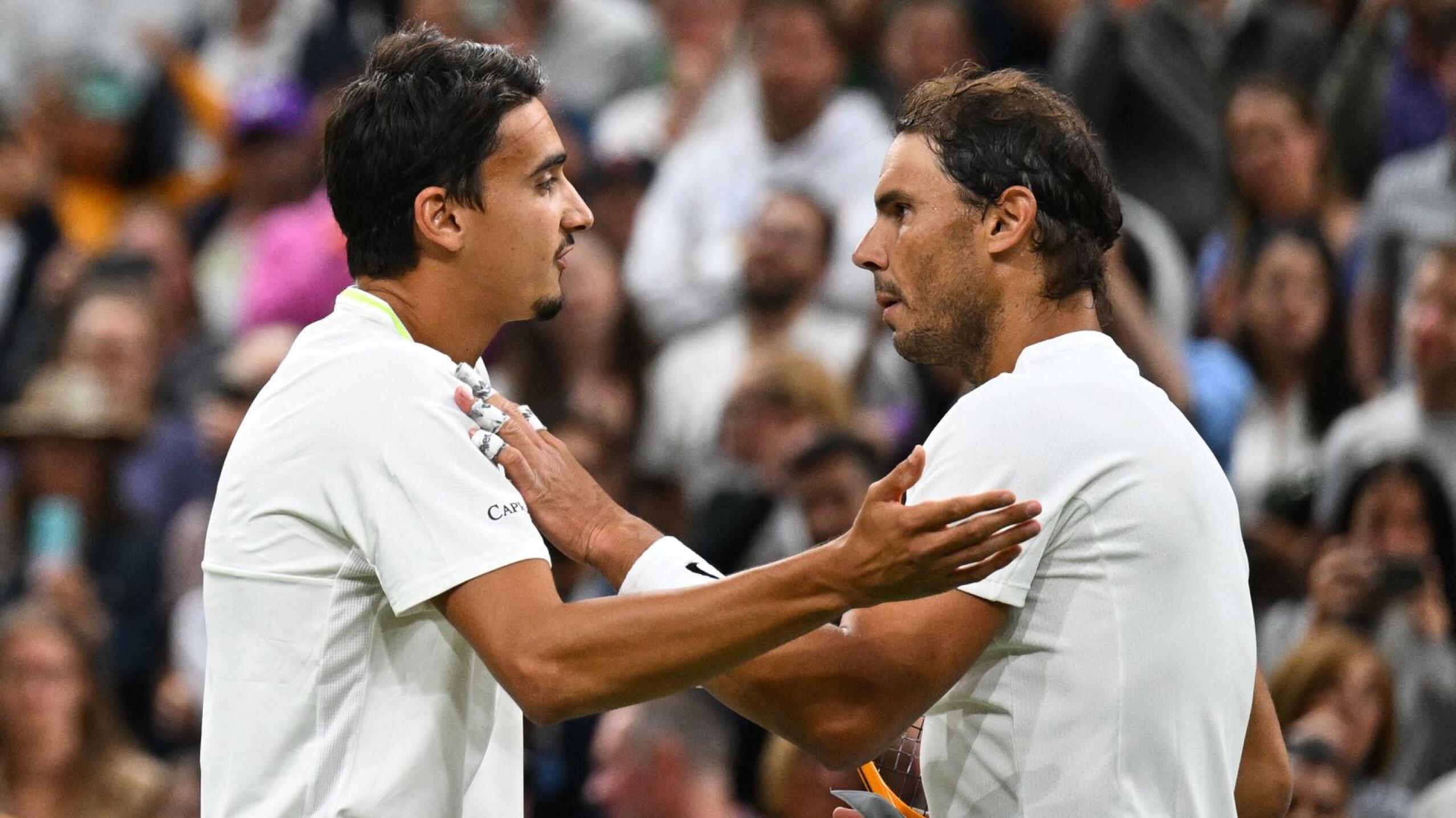 Spain's Rafael Nadal speaks with Italy's Lorenzo Sonego after winning in their men's singles tennis match on the sixth day of the 2022 Wimbledon Championships at The All England Tennis Club in Wimbledon, southwest London, on Saturday