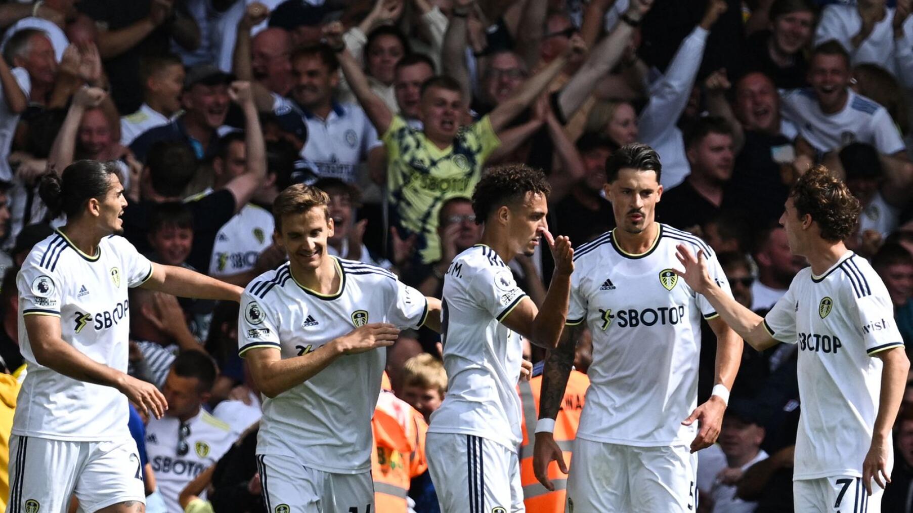 Leeds United's Brazilian-born Spanish striker Rodrigo celebrates with teammates after scoring his team’s second goal during their Premier League match against Chelsea at Elland Road in Leeds on Sunday