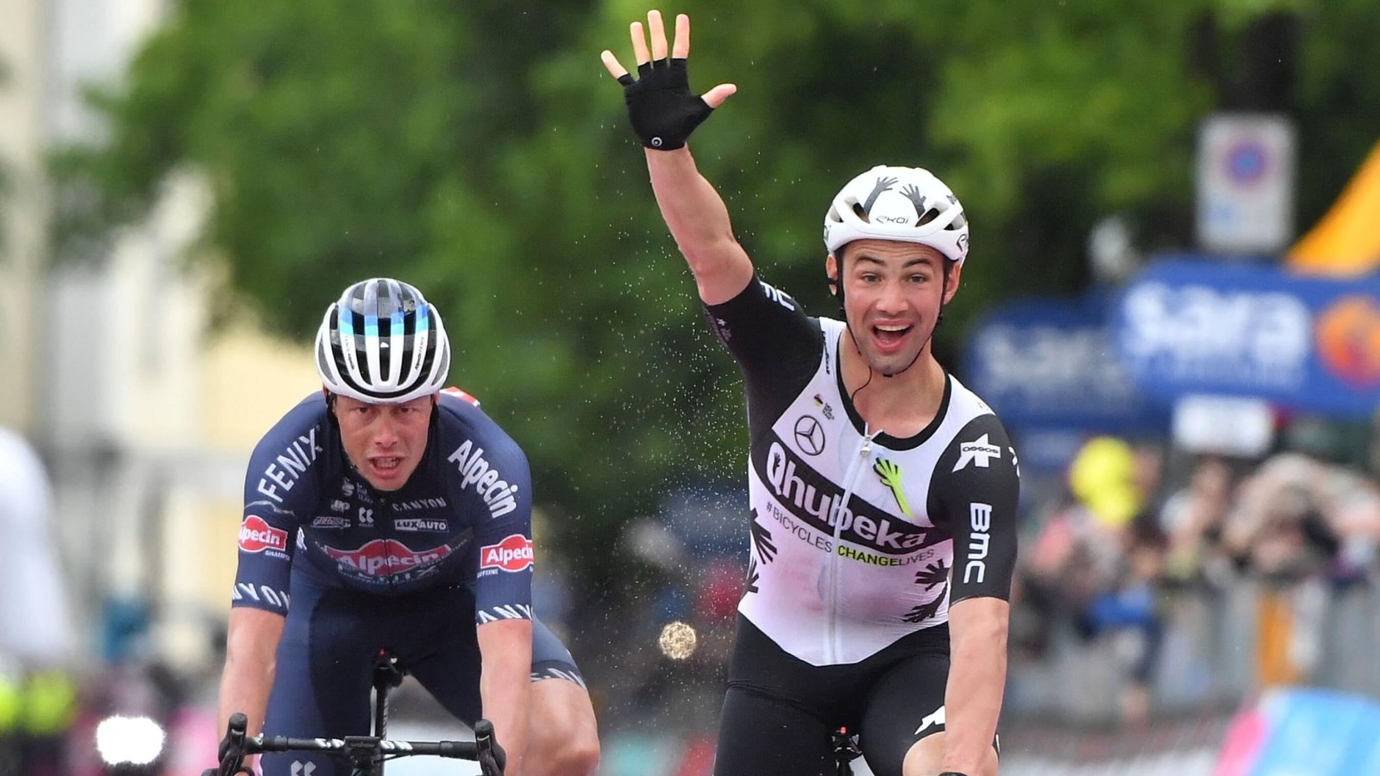 Qhubeka Assos rider Victor Campenaerts of Belgium celebrates winning stage 15 ahead of Alpecin-Fenix rider Oscar Riesebeek of Netherlands
