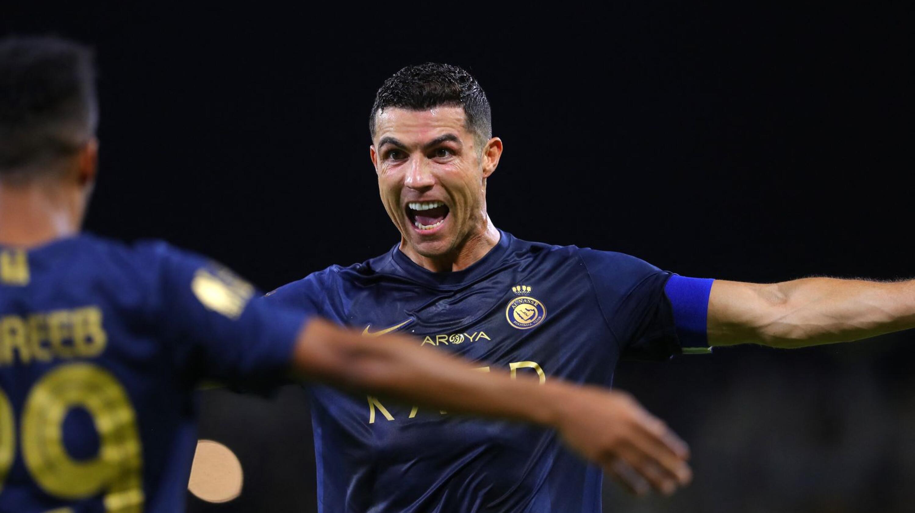 Cristiano Ronaldo celebrates with Abdulrahman Ghareeb after scoring a goal for Al-Nassr