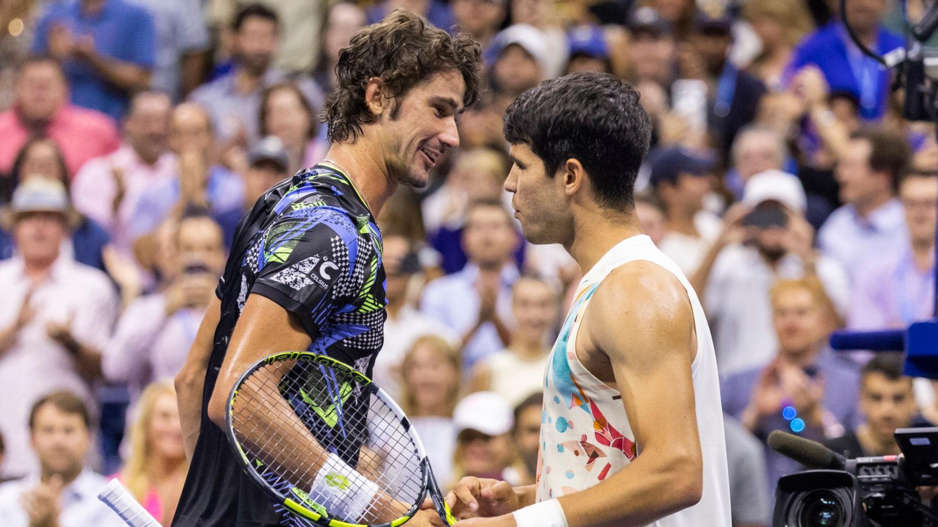 Spain's Carlos Alcaraz (R) shakes hands with South Africa's Lloyd Harris after winning their US Open tennis tournament men's singles second round match at the USTA Billie Jean King National Tennis Center in New York City