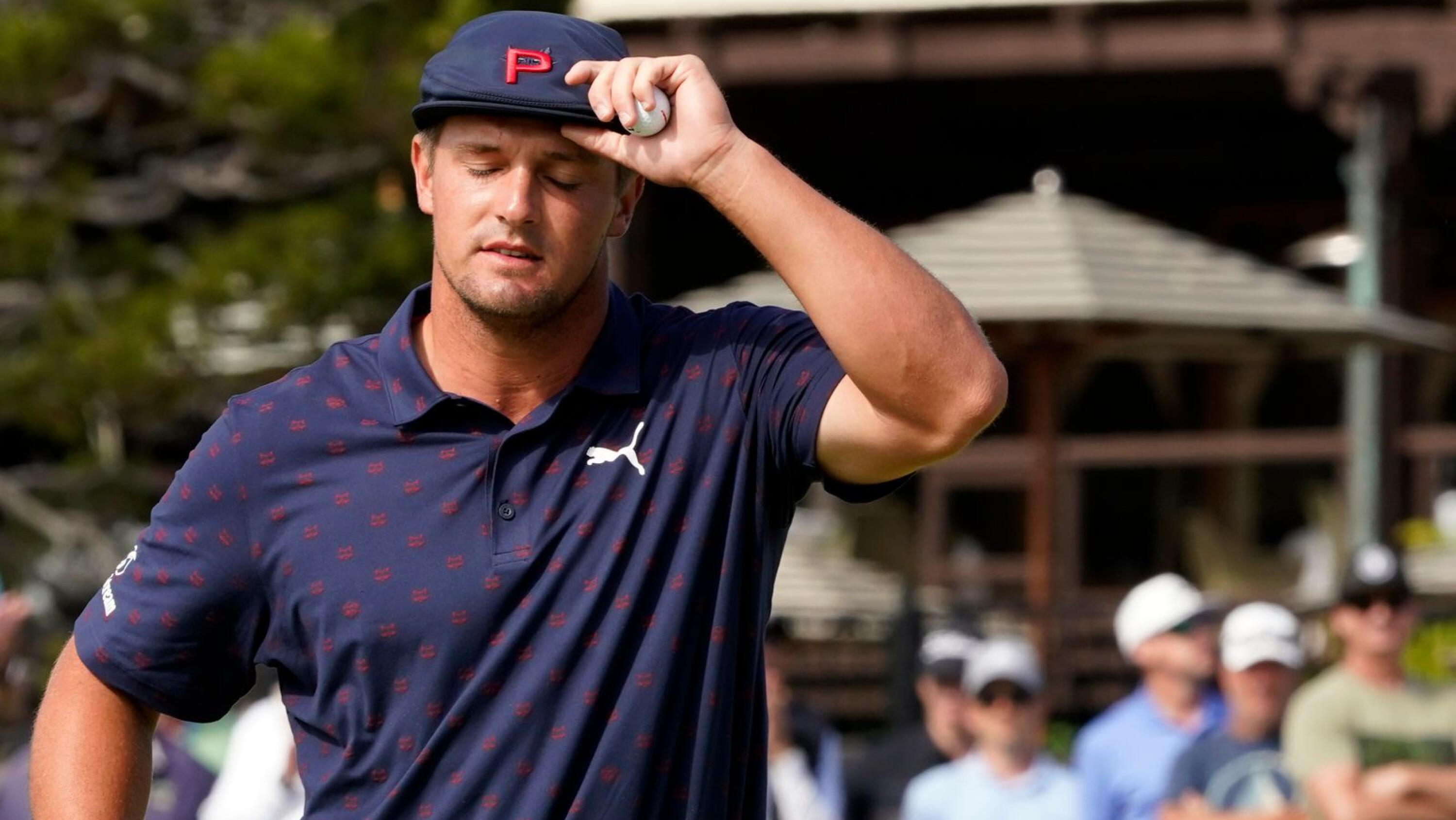 Bryson DeChambeau tips his hat after putting out on the 18th green during the third round of the US Open golf tournament at Torrey Pines Golf Course