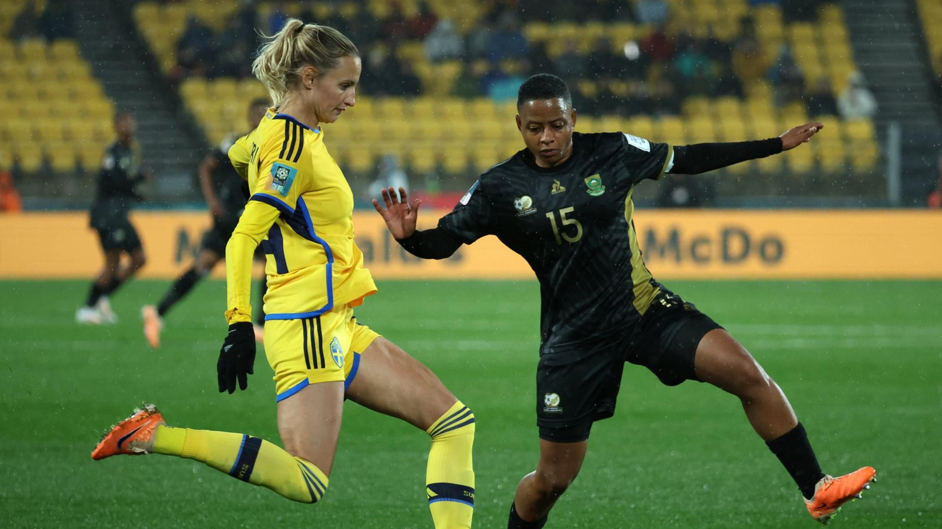 Sweden's defender Nathalie Bjorn (L) is challenged by South Africa's midfielder  Refiloe Jane (R).