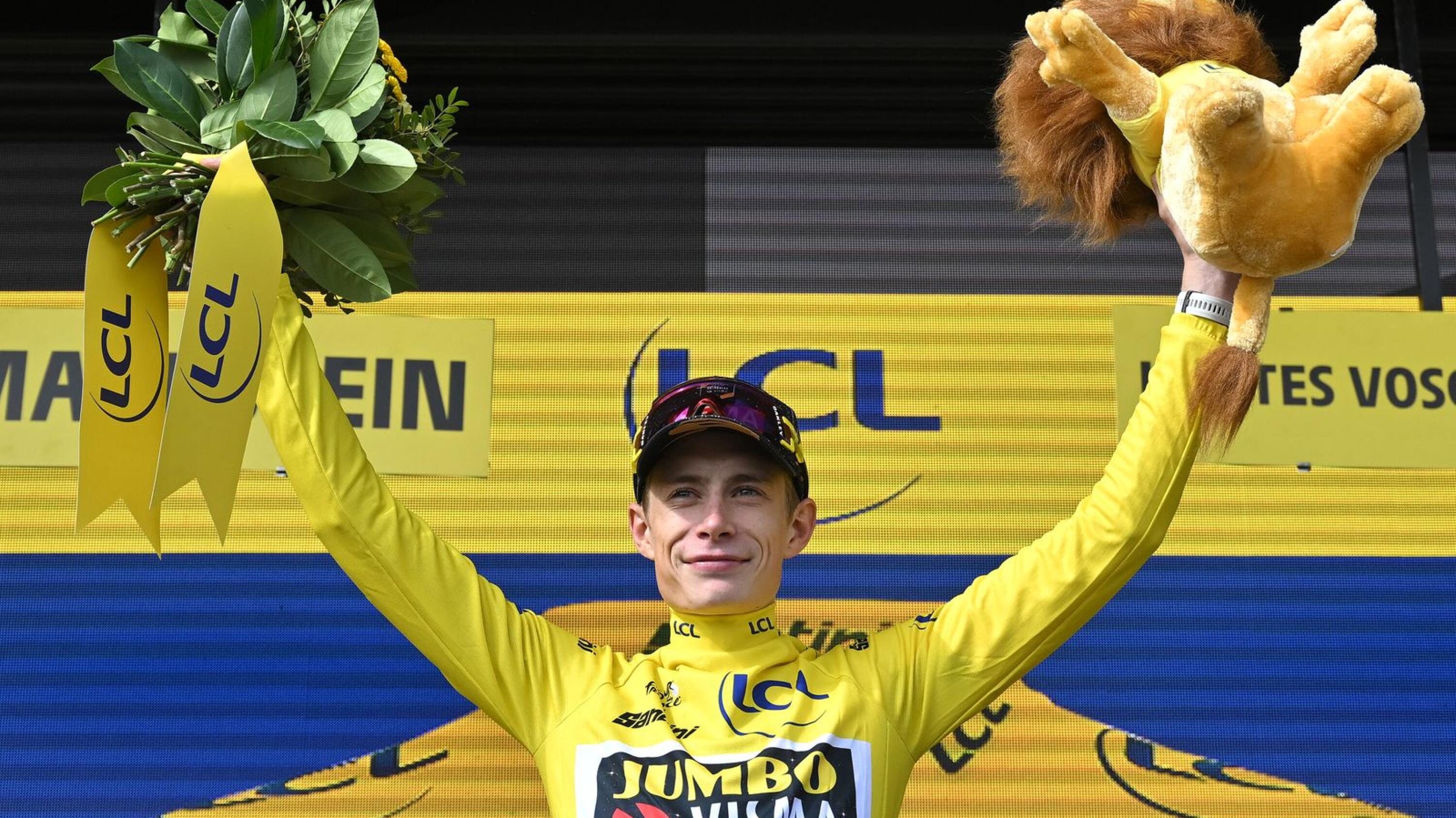 Jumbo-Visma's Danish rider Jonas Vingegaard celebrates on the podium with the overall leader's yellow jersey after the 20th stage of the 110th edition of the Tour de France cycling race on Saturday