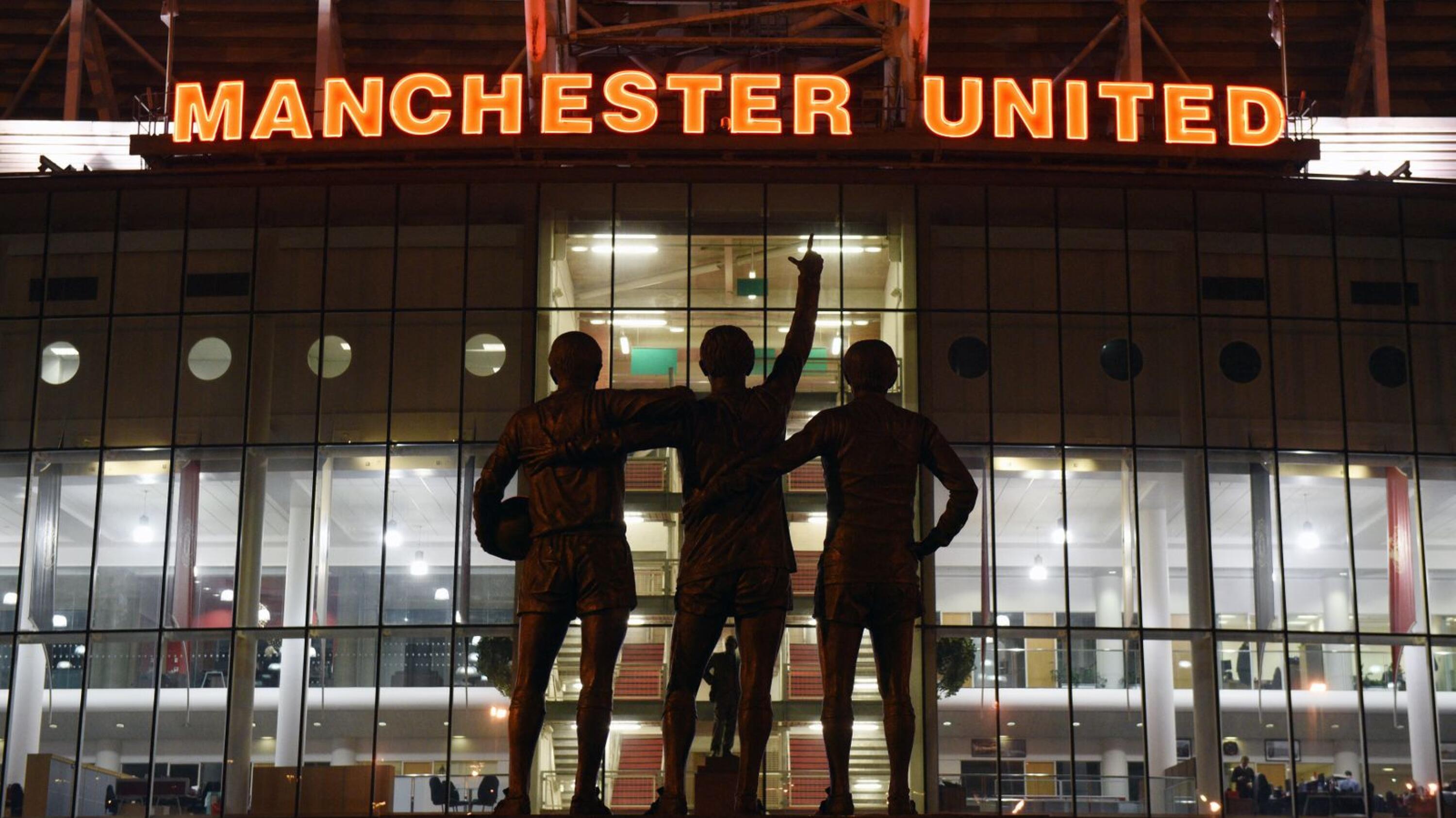 A general view outside Old Trafford stadium and 'The United Trinity' statue of former Manchester United players George Best, Denis Law, and Bobby Charlton