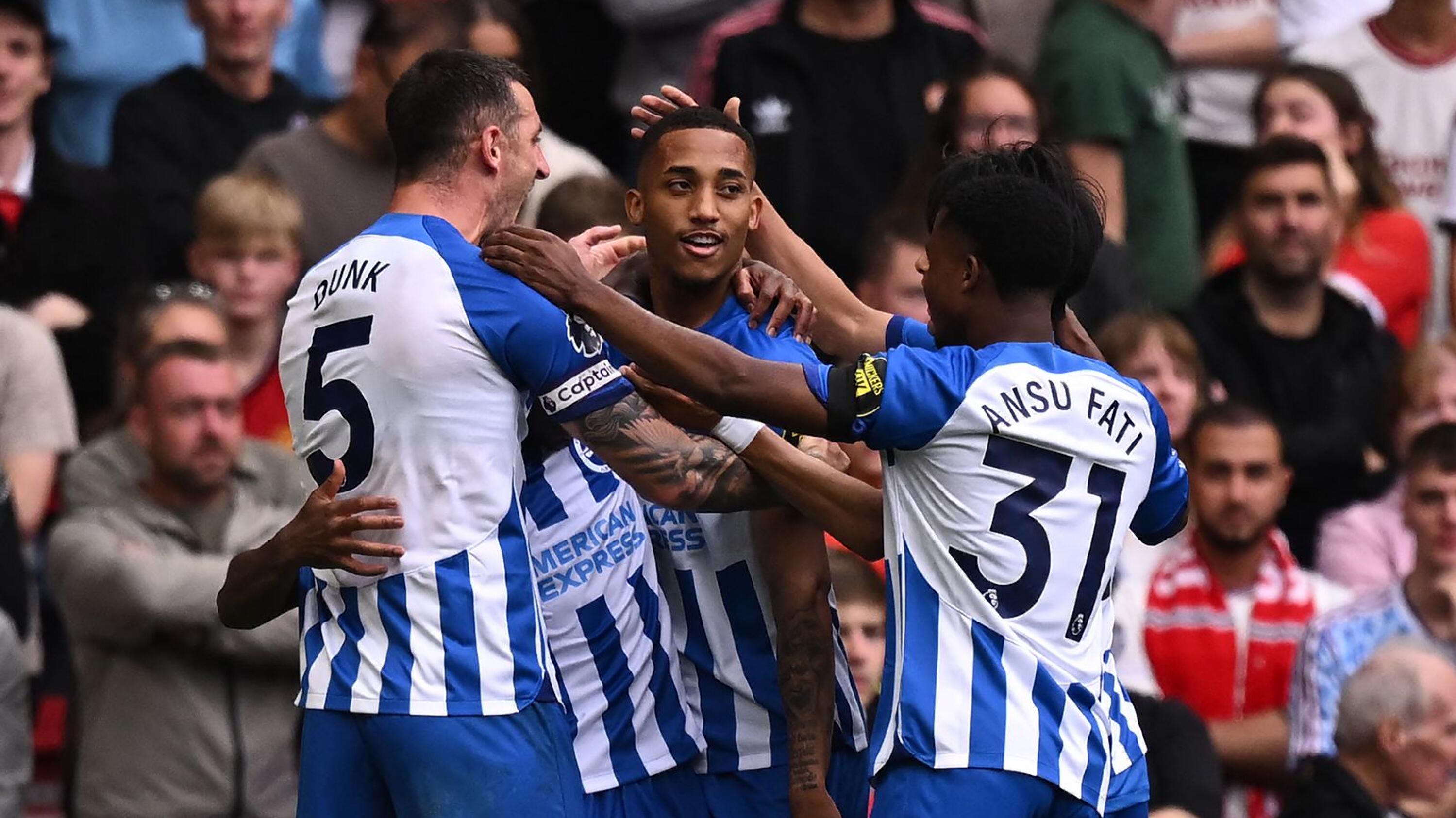 Brighton's Joao Pedro celebrates with teammates after scoring their third goal during their Premier League football match against Manchester United