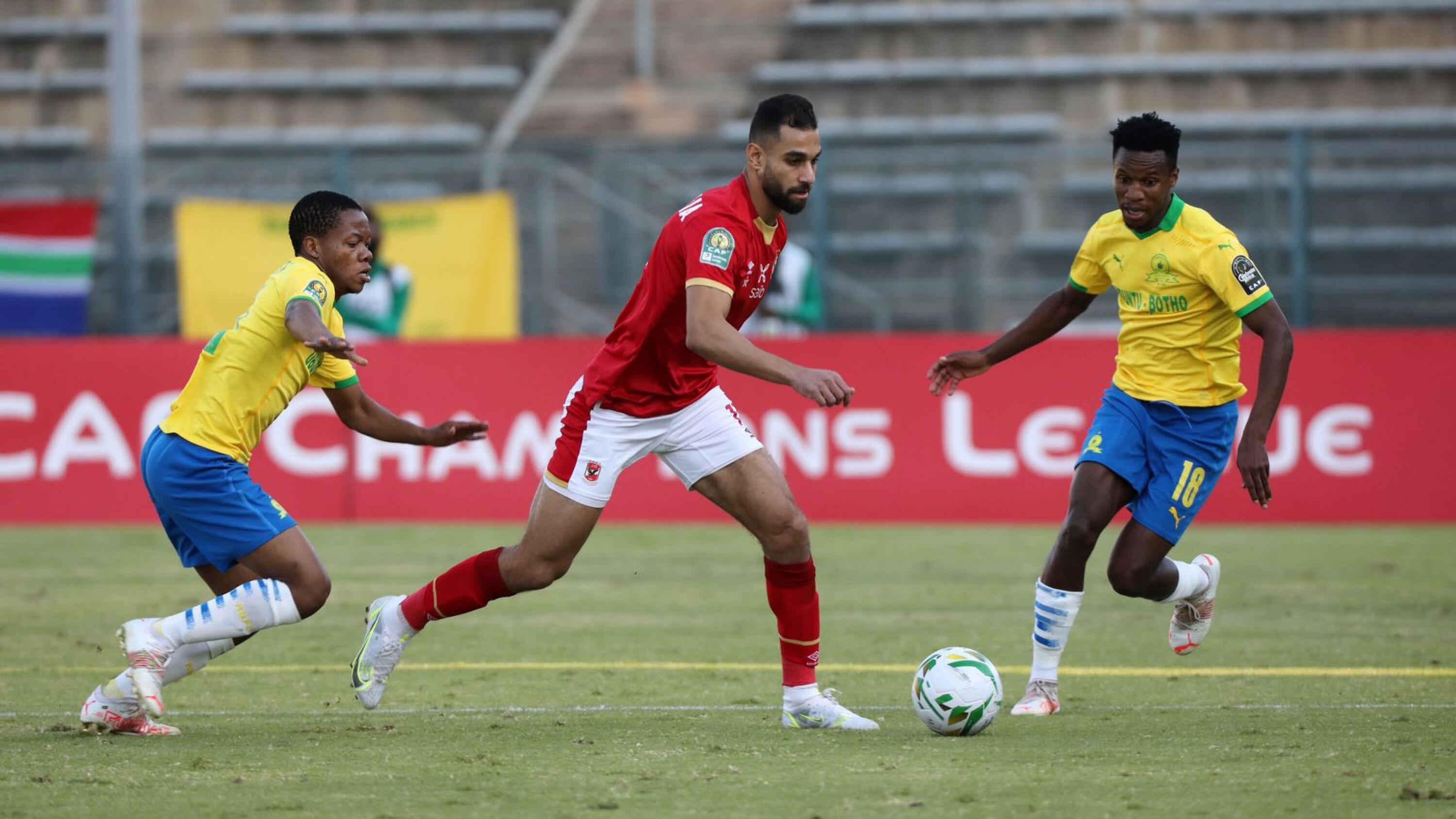 Amro Mohamed Elsoulia of Al Ahly runs with the ball and is  challenged by Sphelele Mkhulise and Themba Zwane of Mamelodi Sundowns during last year’s CAF Champions League quarter-final meeting at Lucas Moripe Stadium in Tshwane