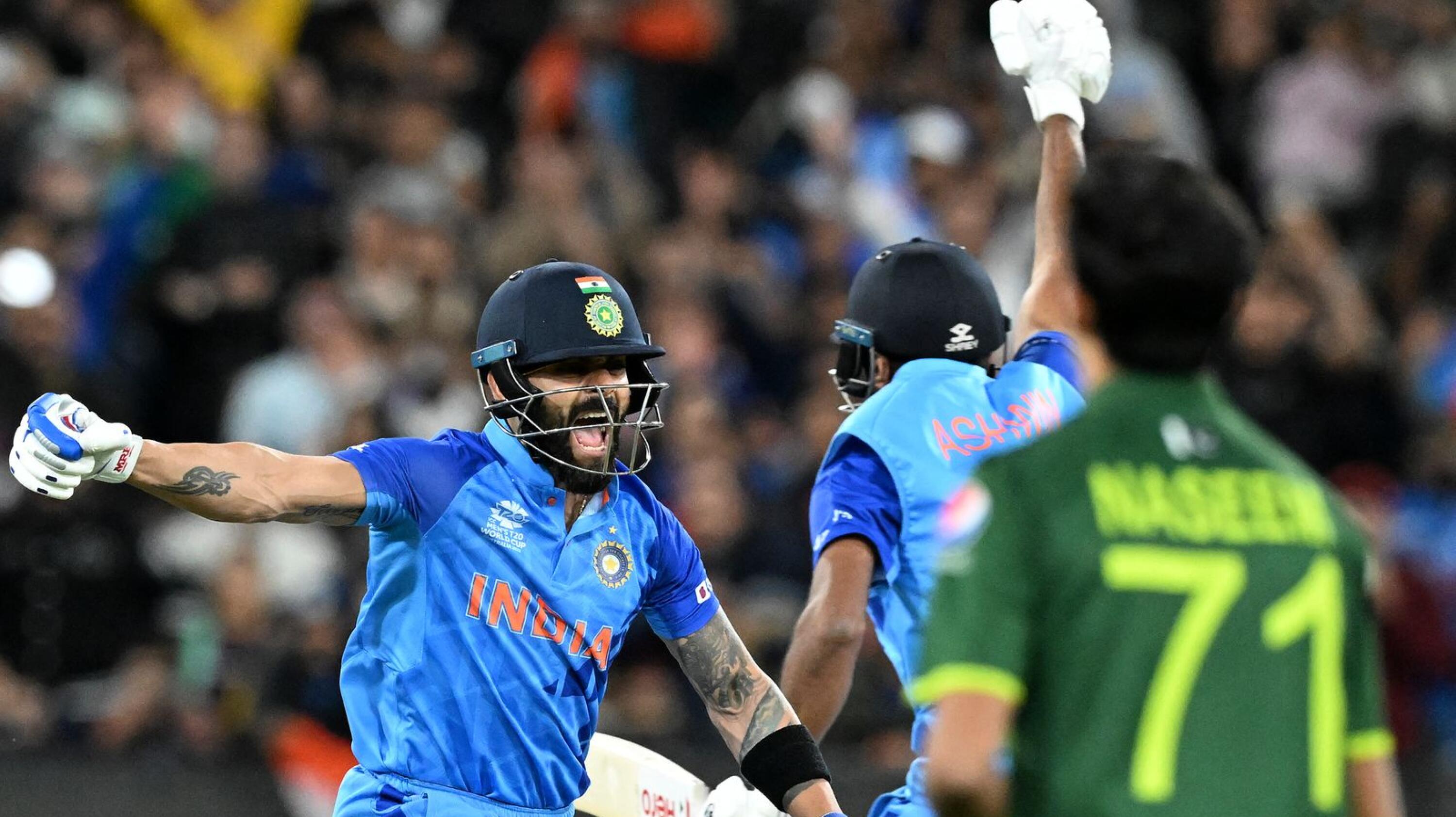 India's Virat Kohli celebrates with Ravichandran Ashwin after they secured their win over Pakistan in their T20 World Cup cricket match at Melbourne Cricket Ground in Melbourne on Sunday