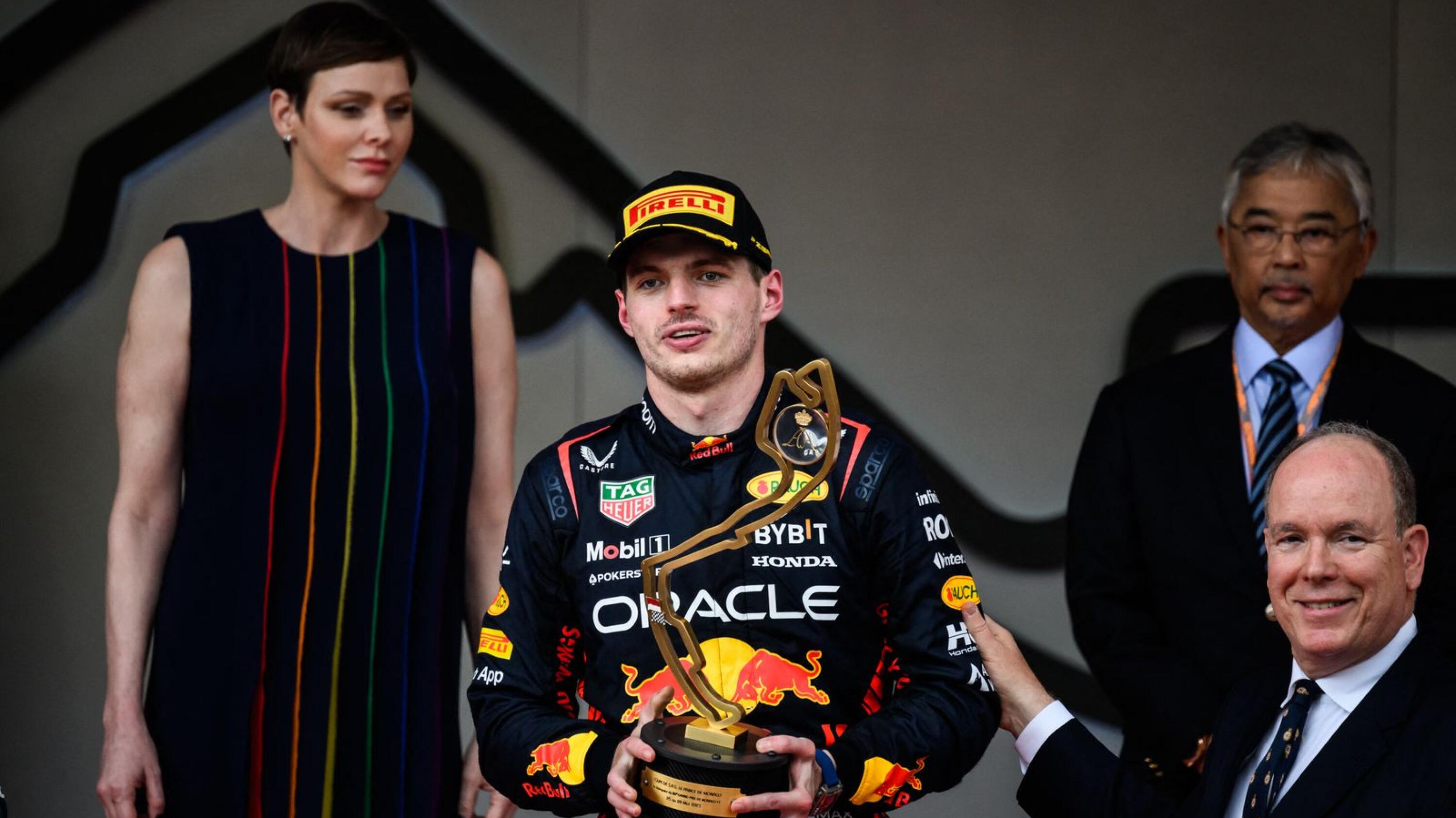 Max Verstappen holds up his trophy flanked by Prince Albert II and Princess Charlene of Monaco on the podium after winning the Monaco Grand Prix on Sunday.