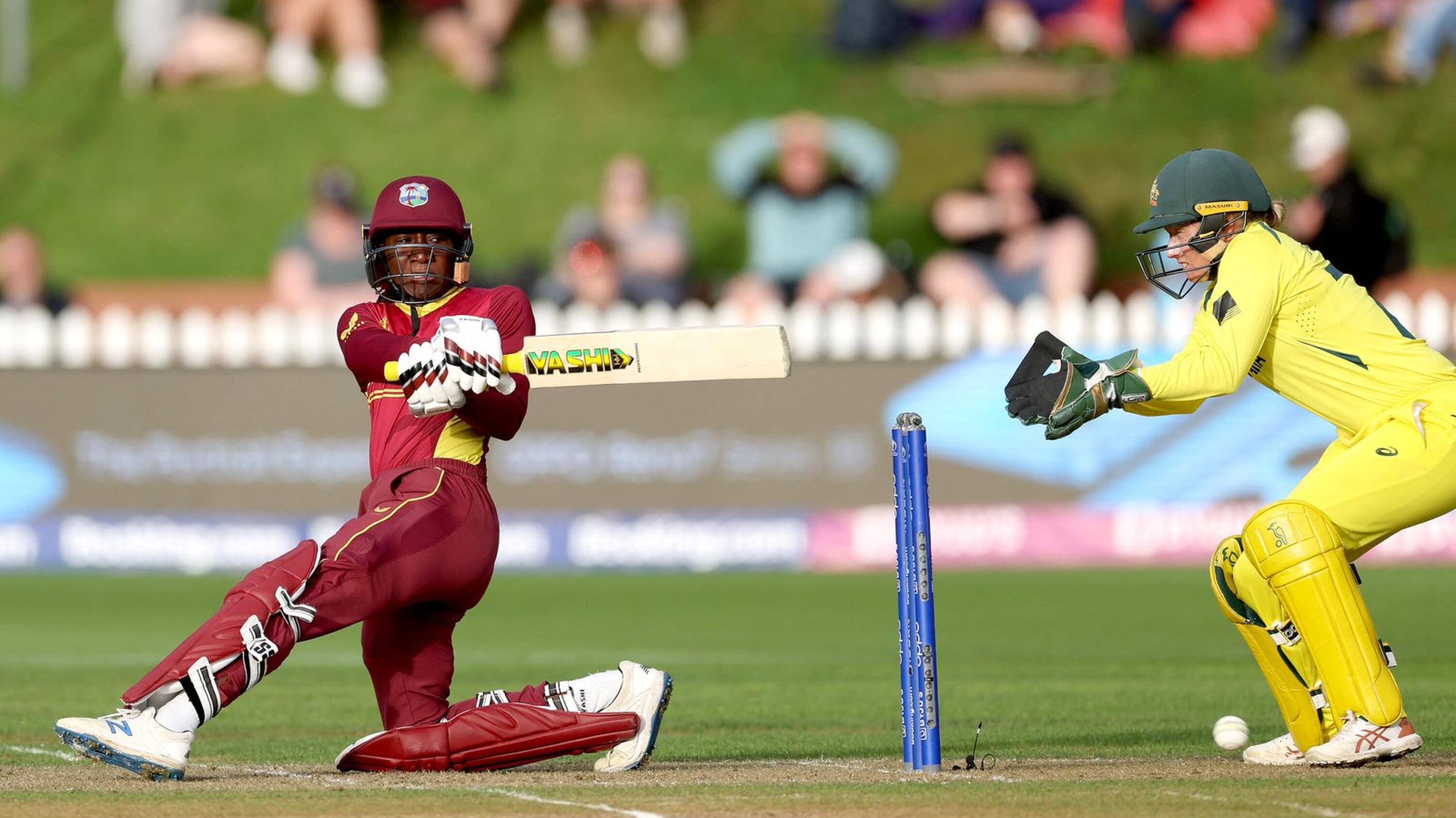 West Indies' captain Stafanie Taylor plays a shot watched by the Australia's wicketkeeper Alyssa Healy (R) during their Women's Cricket World Cup semi-final match at the Basin Reserve in Wellington