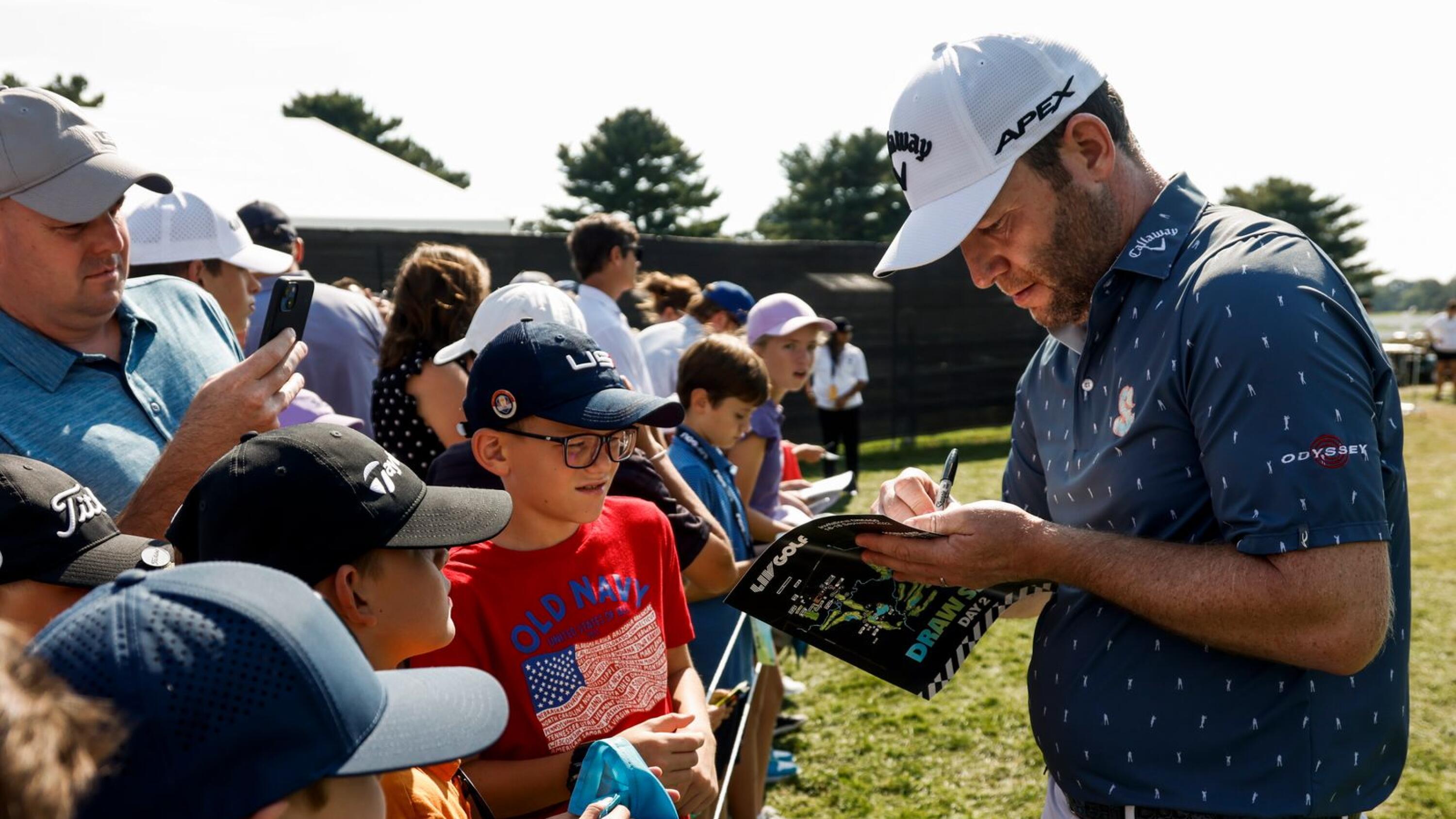 South African Branden Grace signing autographs at a LIV Golf event