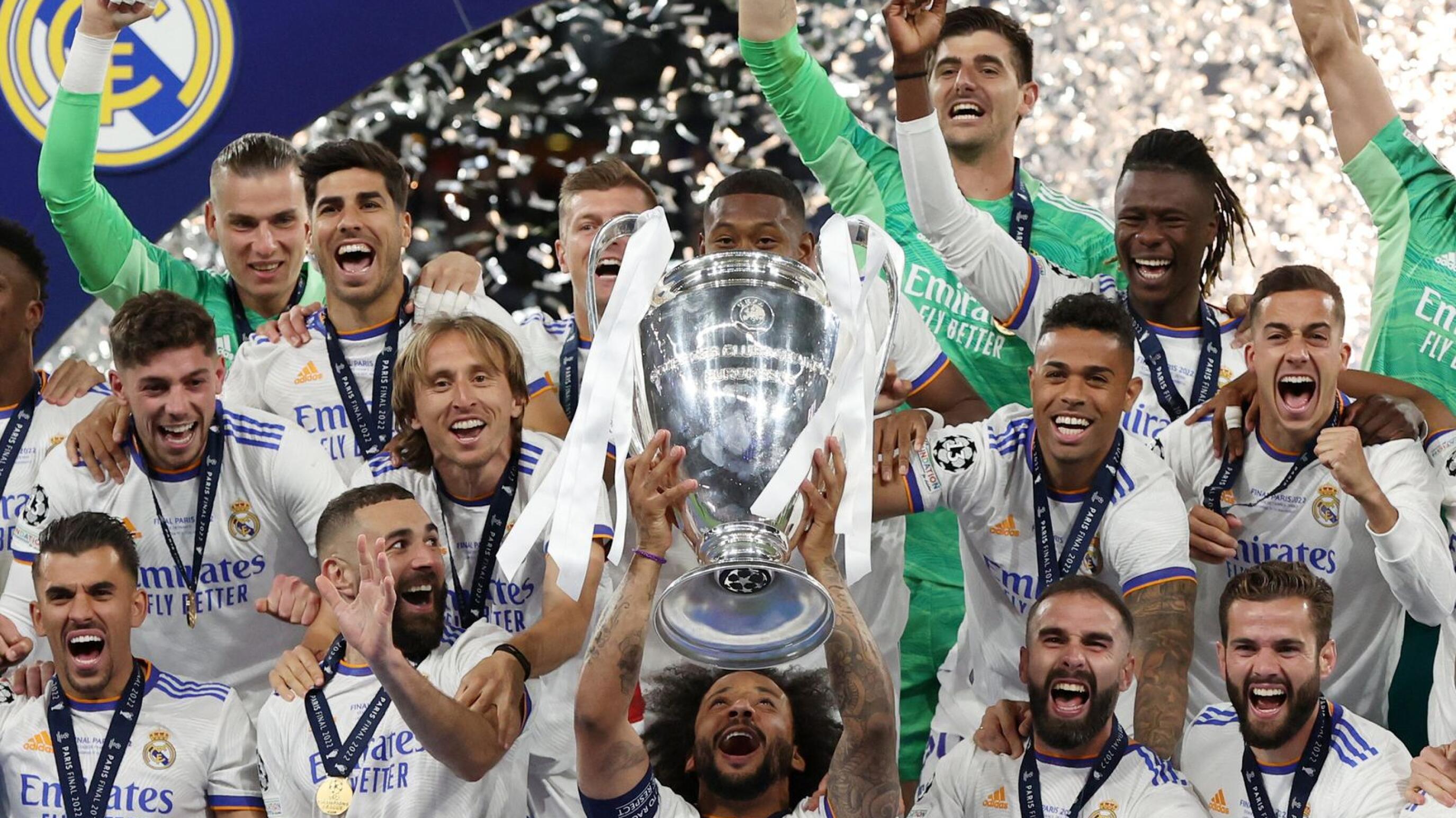 Real Madrid's Marcelo celebrates with the trophy and teammates after the club beat Liverpool in the Champions League in Paris on Saturday