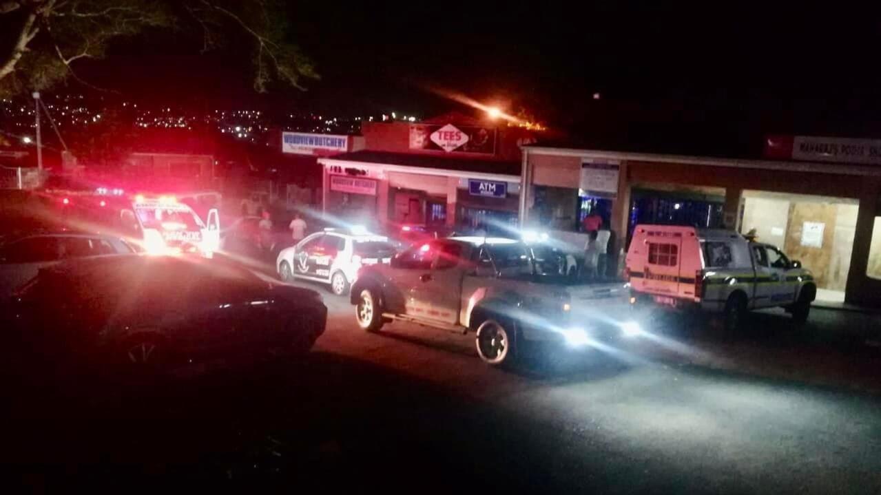 Police and security vehicles outside a business at night. 