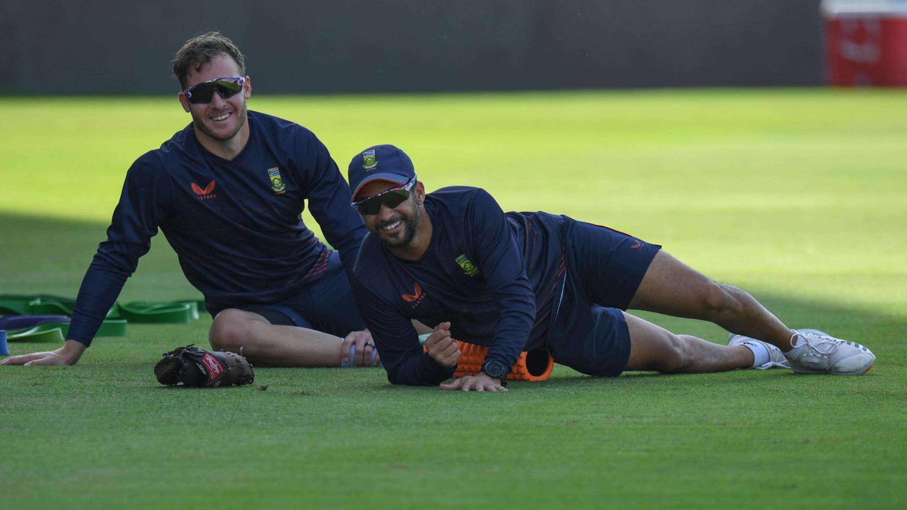 Proteas batter David Miller (L) and JP Duminy stretch during a training session ahead 