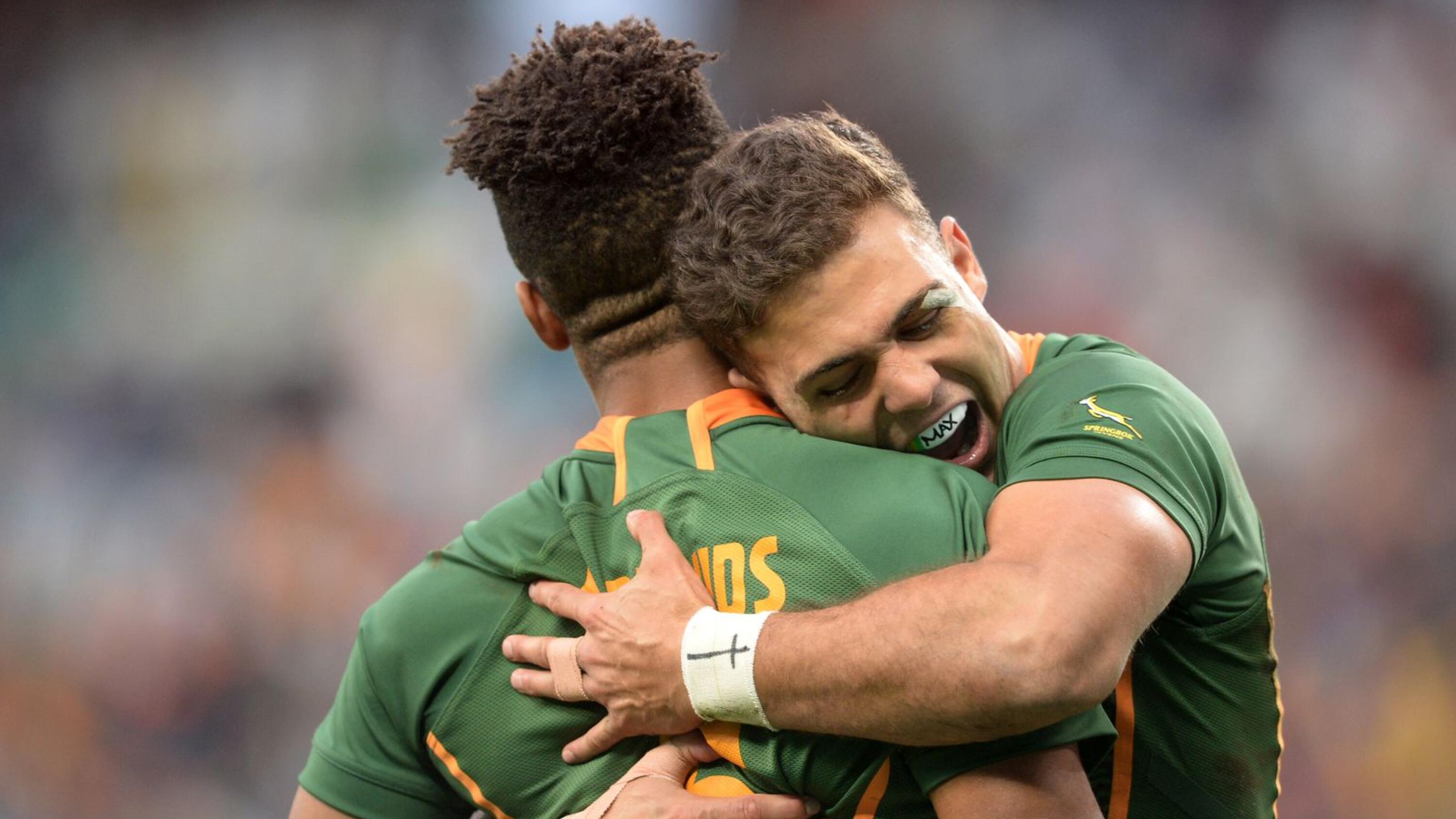 Muller du Plessis of South Africa celebrates with try scorer Angelo Davids during day three of the Rugby World Cup Sevens tournament at Cape Town Stadium on Sunday
