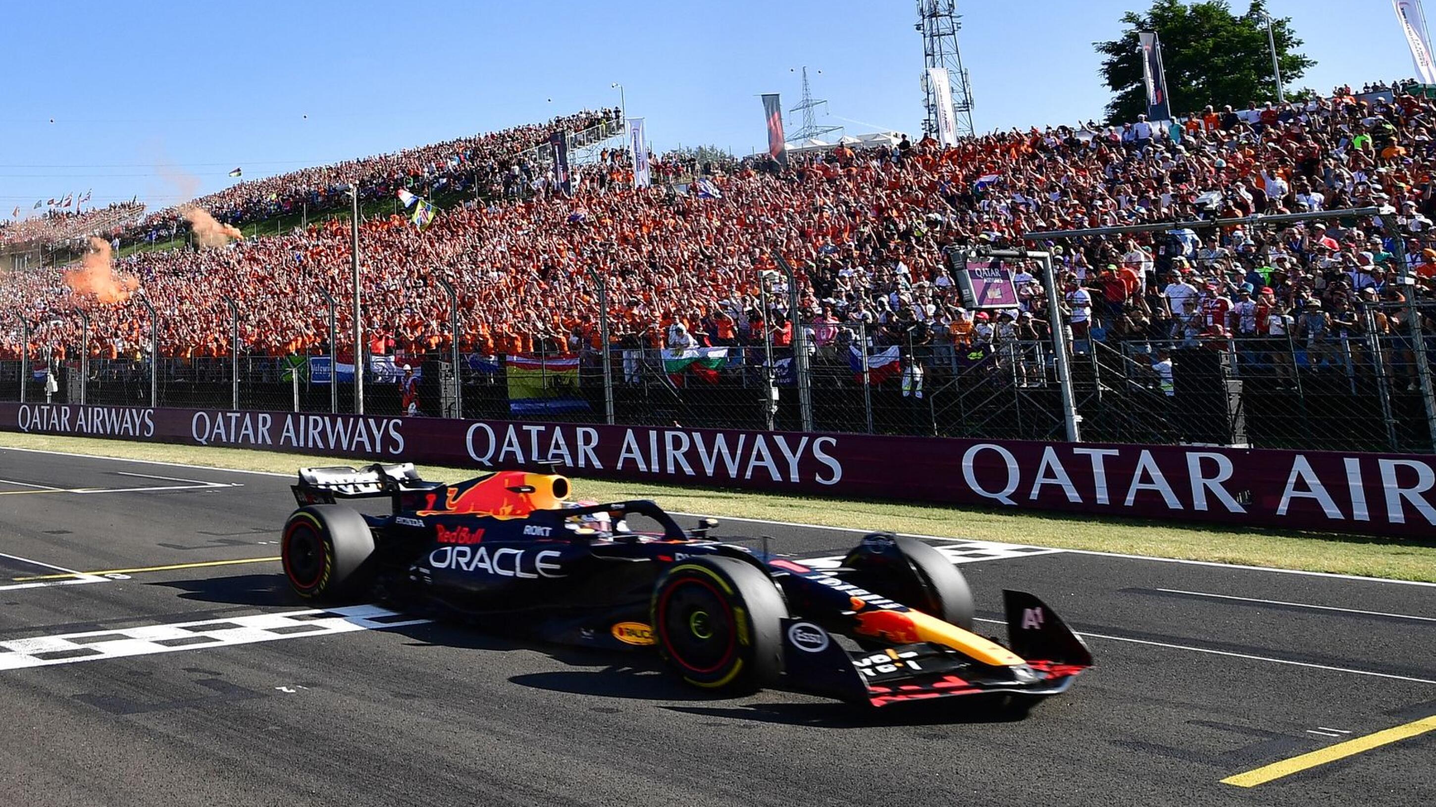 Red Bull Racing's Dutch driver Max Verstappen crosses the finish line to win the Formula One Hungarian Grand Prix at the Hungaroring race track in Mogyorod near Budapest