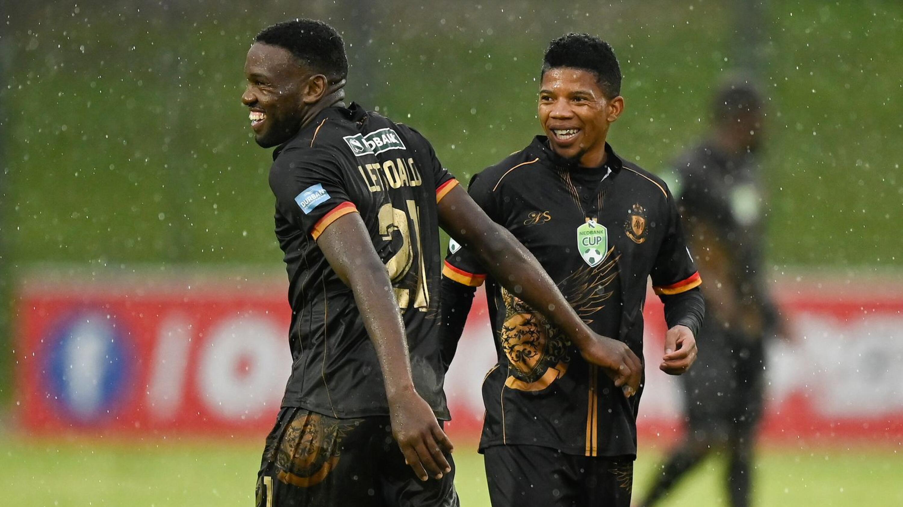 Royal AM’s Victor Letsoale and Tebogo Potsane celebrate at the end of their Nedbank Cup quarter-final game against the University of Pretoria on Sunday