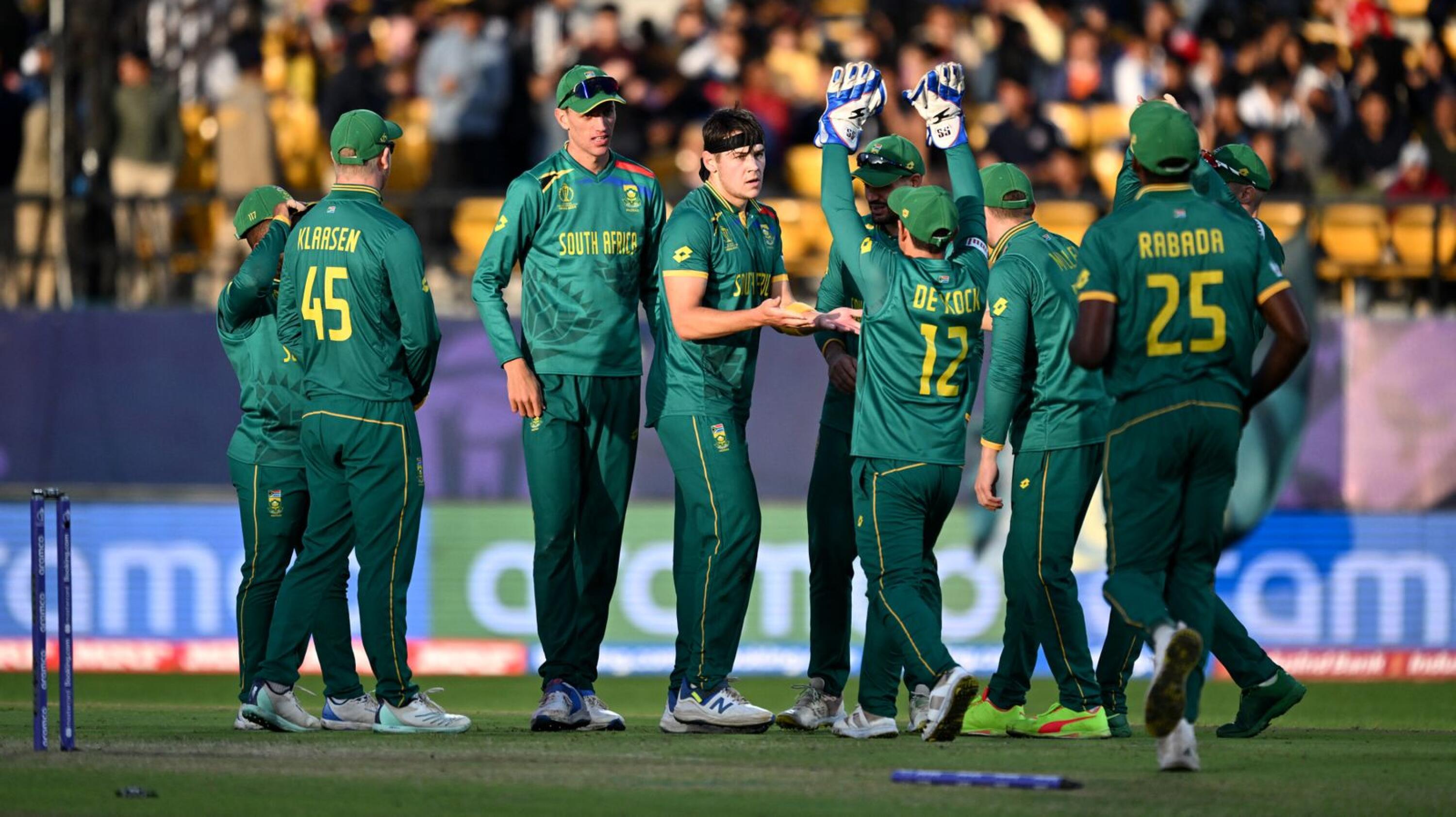 Proteas bowler Gerald Coetzee (C) celebrates with teammates after taking the wicket of Netherlands' Colin Ackermann