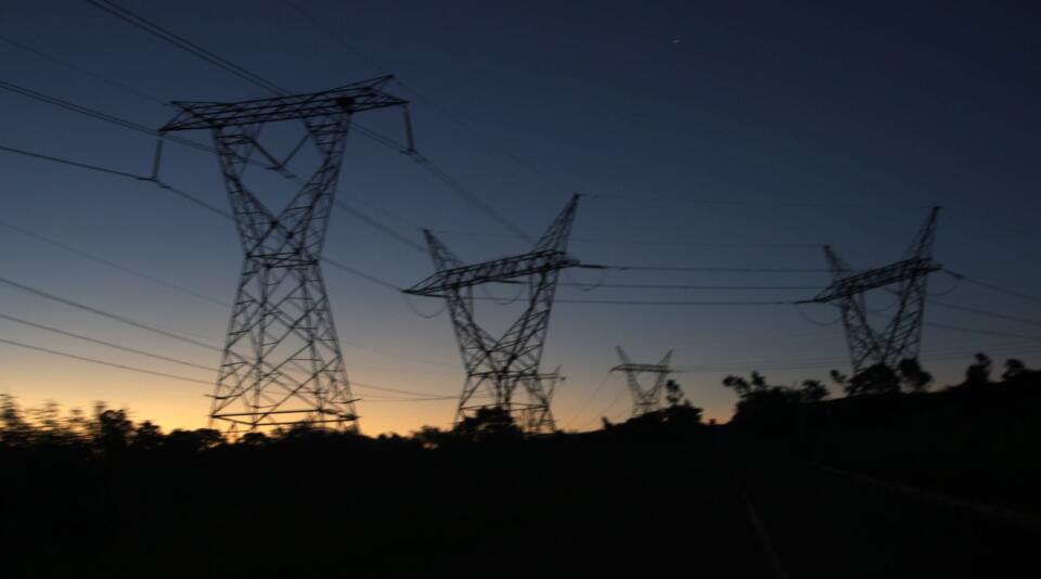 Electricity pylons seen at sunset.