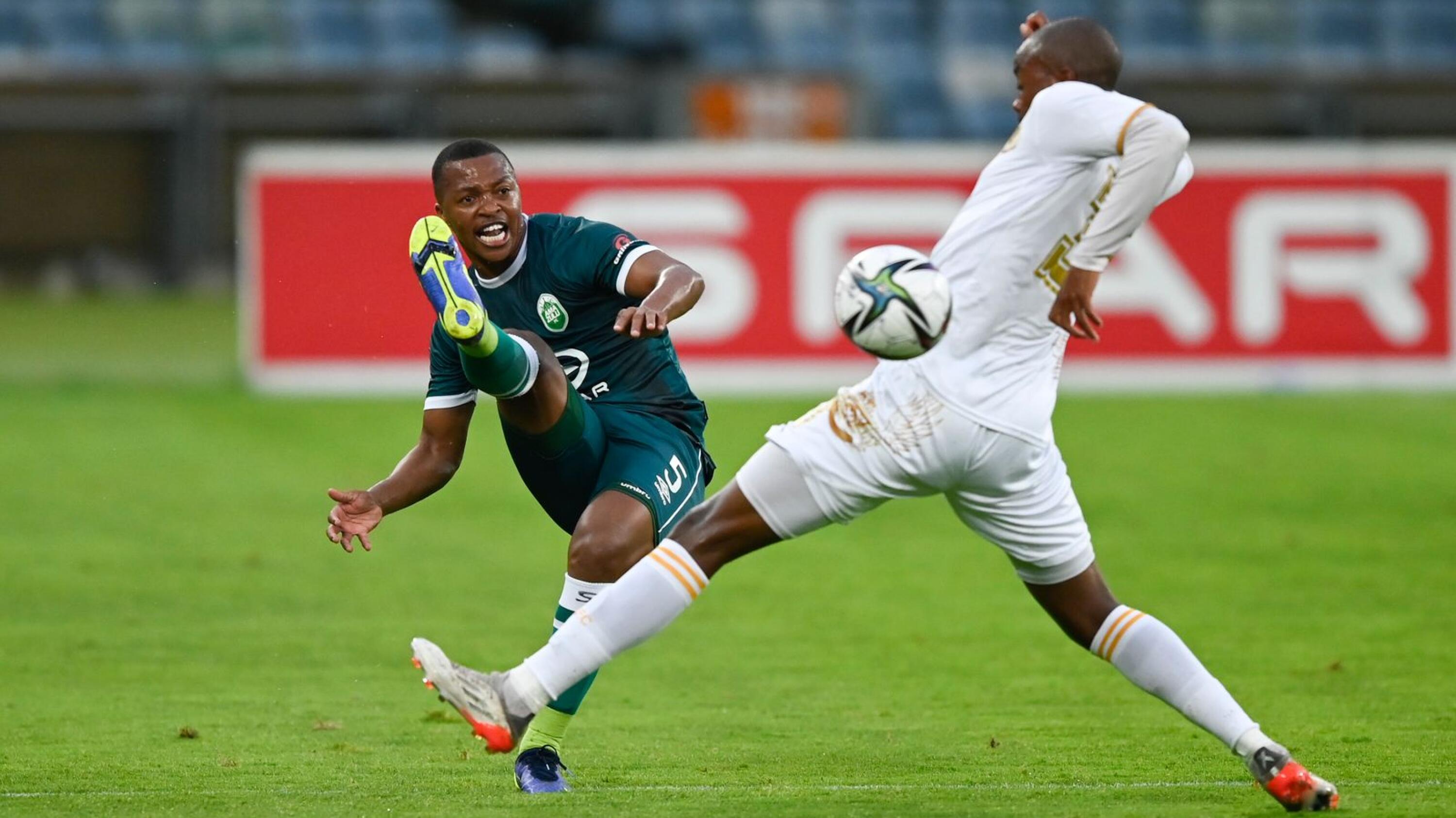Thembela Sikhakhane of AmaZulu FC boots the ball past Levy Masiane of Royal AM FC during their DStv Premiership match at Moses Mabhida Stadium in Durban on Saturday